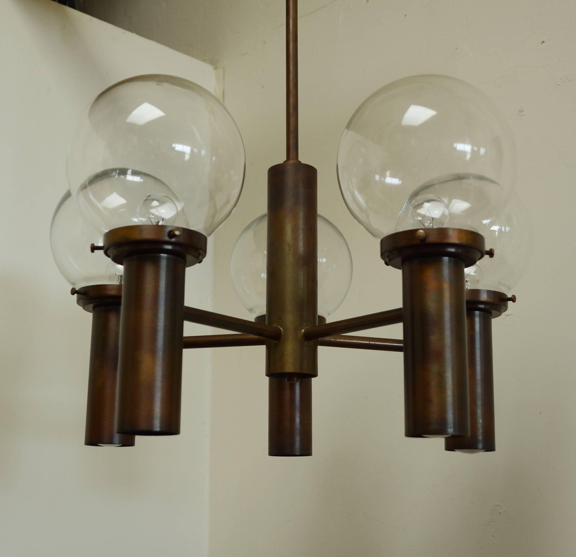 Stuart Barnes designed chandelier for Robert Long. This chandelier has an oiled brass finish. This chandelier has ten lamps, five up and five down. There is a switch that allows either the up or down lights to be on or both. The height can be