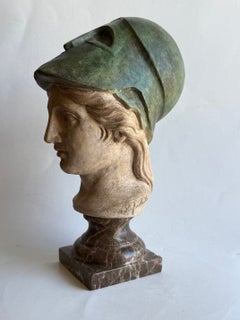 Atena in ceramica, elmo con patina bronzea, su base tornita in marmo Emperador