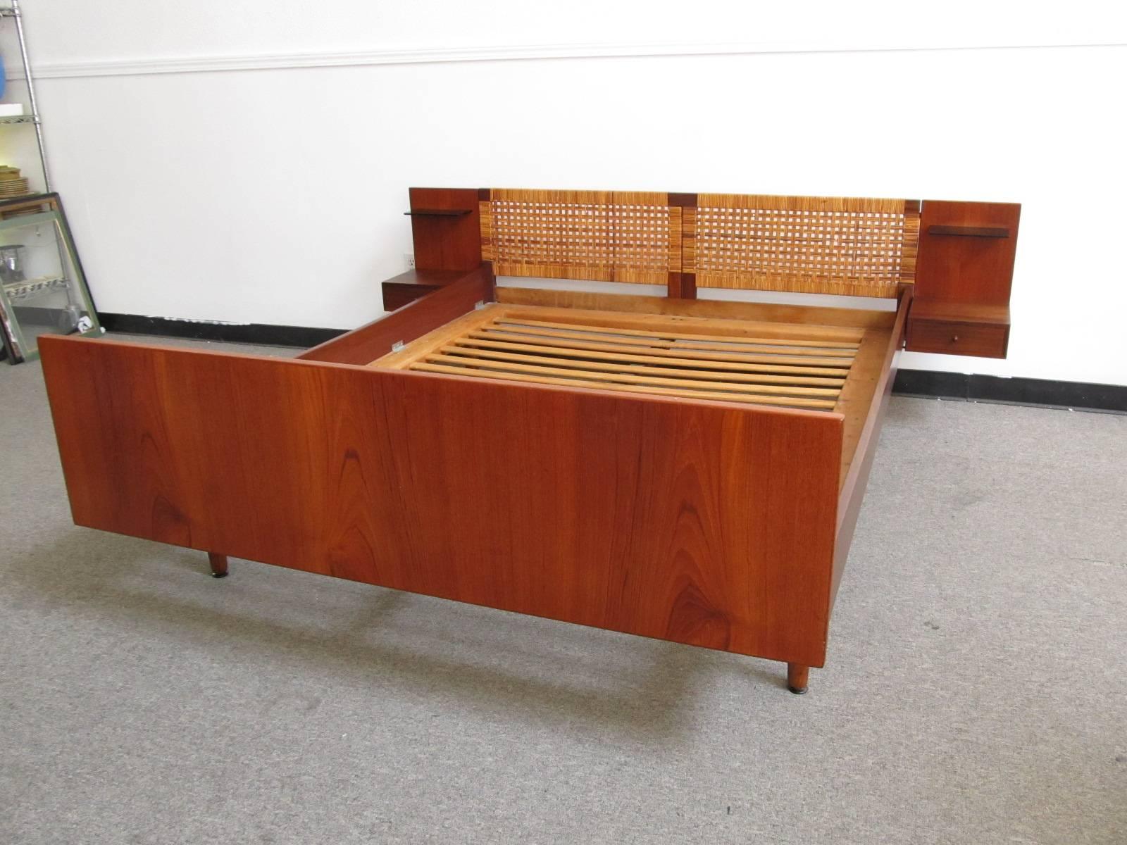 This truly lovely Hans Wegner bed is something a little unusual. Many Hans Wegner beds have a vinyl upholstered foot board. This one however has a beautiful teak foot board. But obviously, its most desirable feature is the two attached nightstands