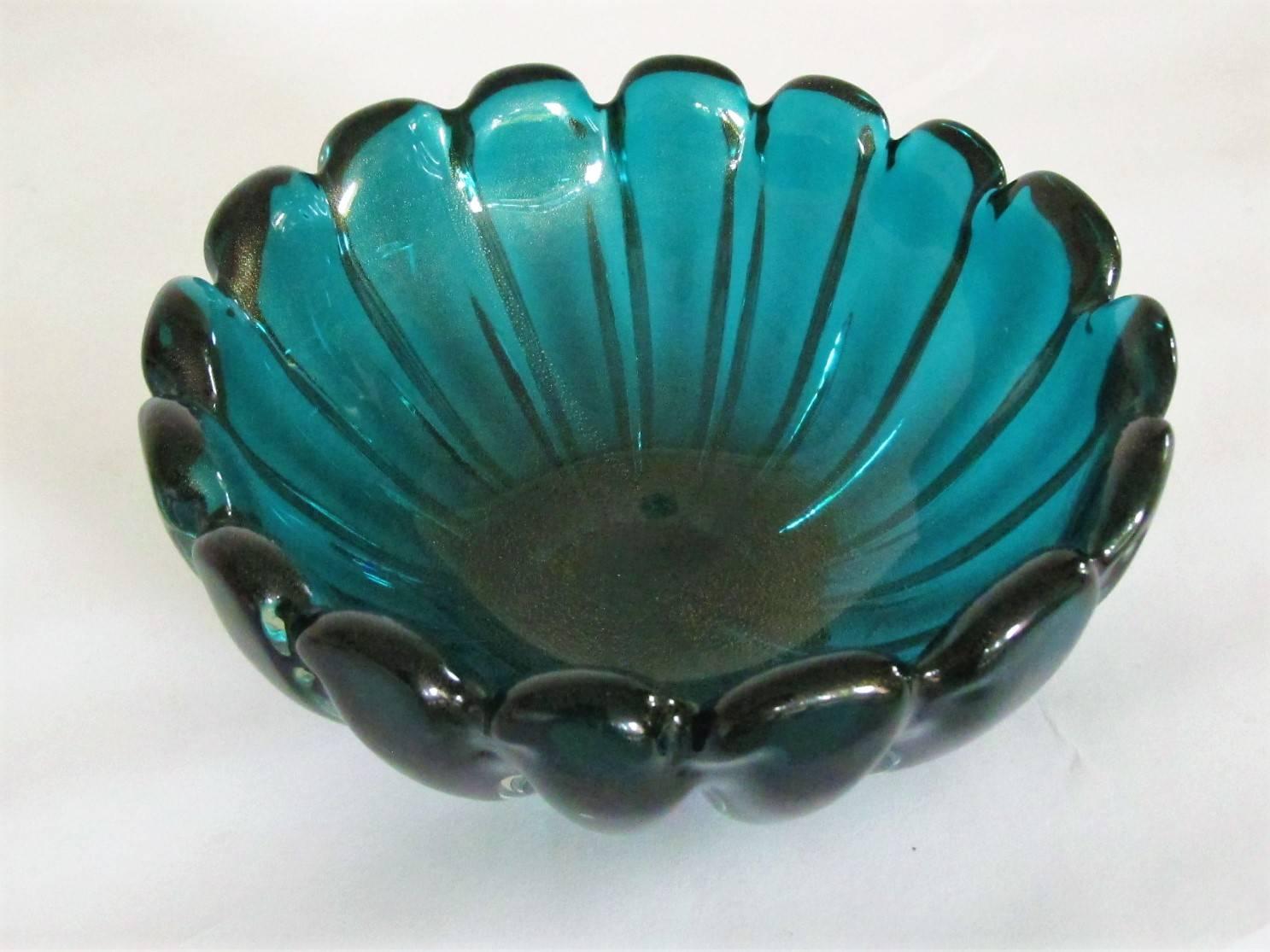 The form and the flow of this bowl are beautiful. But the color is stunning. Rare aquamarine with a galaxy of gold flake running through the interior. Minor damage and roughness to the bottom, but unnoticeable in normal usage.