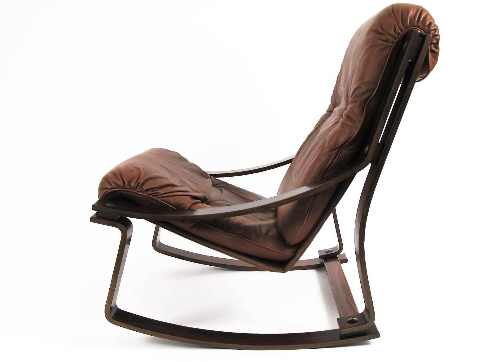 This is a somewhat rare chair from the Westnofa Furniture company in Norway. Made from rosewood veneered bent plywood with leather cushions.
