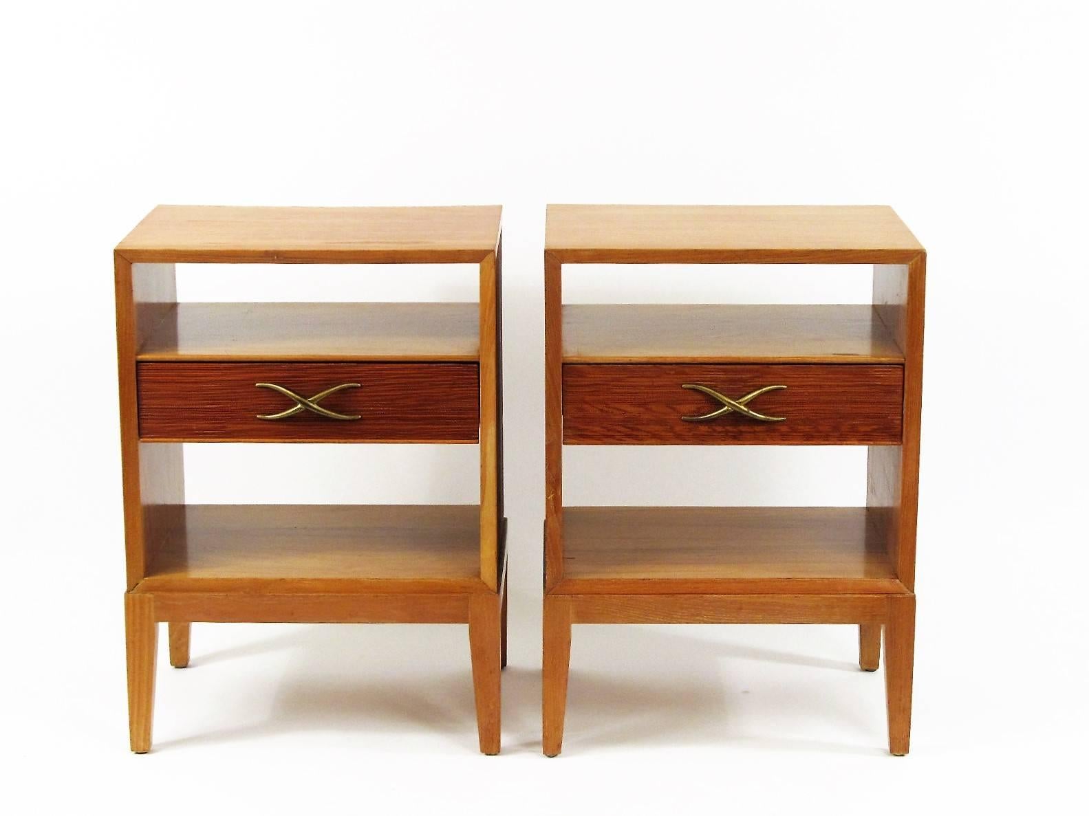 Paul Frankl was a leading American designer in the 1930s and 1940s. His oeuvre varied from Art Deco, to Asian inspired Mid-Century design. The night stands feature Frankl's signature combed wood exterior and X-drawer pulls.