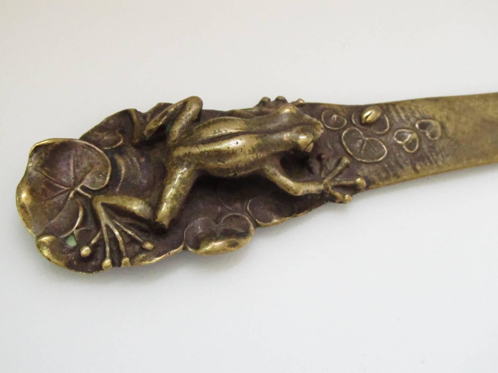 This charming letter opener has a 3 dimensional figural frog stalking an insect sitting on a lily pad. The moment of anticipation, frozen in time. It's a beautiful representation of Japanese art at the turn of the 20th century. A natural and organic