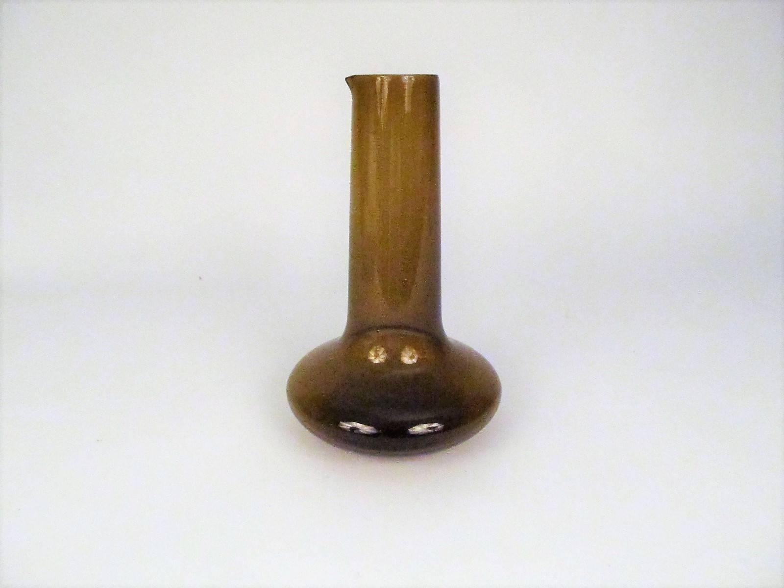 A distinctively elegant and organic form that just asks to be picked up. Although it has a spout, and is obviously a carafe, the word vase also comes to mind.

Signed on the bottom with the initials 