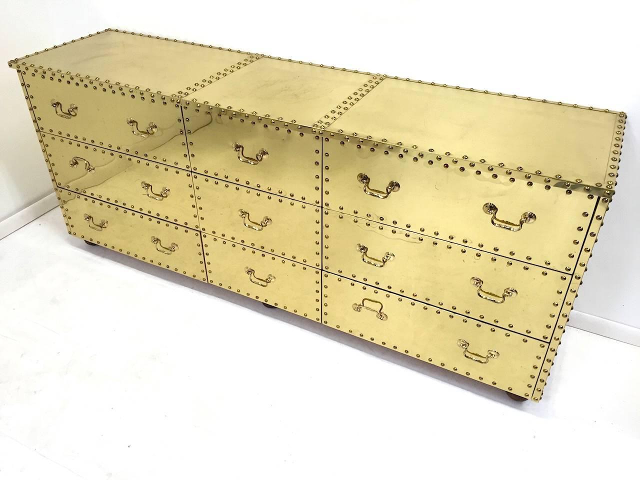 Rare Sarreid Ltd. nine Drawer Brass Clad Chest of Drawers. Good original condition with some age appropriate scratches on the top surface as pictured.  
