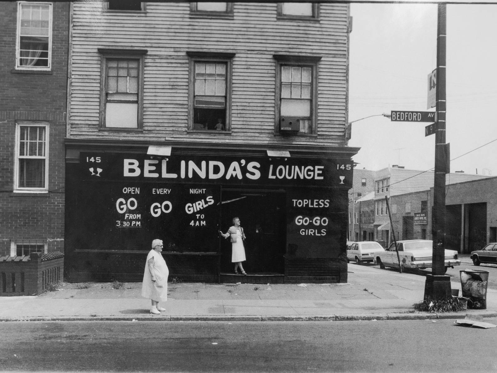 Belinda's lounge by Anders Goldfarb. Goldfarb is a New York photographer who documented the Williamsburg neighborhood of Brooklyn in the 1980s. Hand-printed and signed by the photographer. It will ship in a black gallery frame that shows the raw