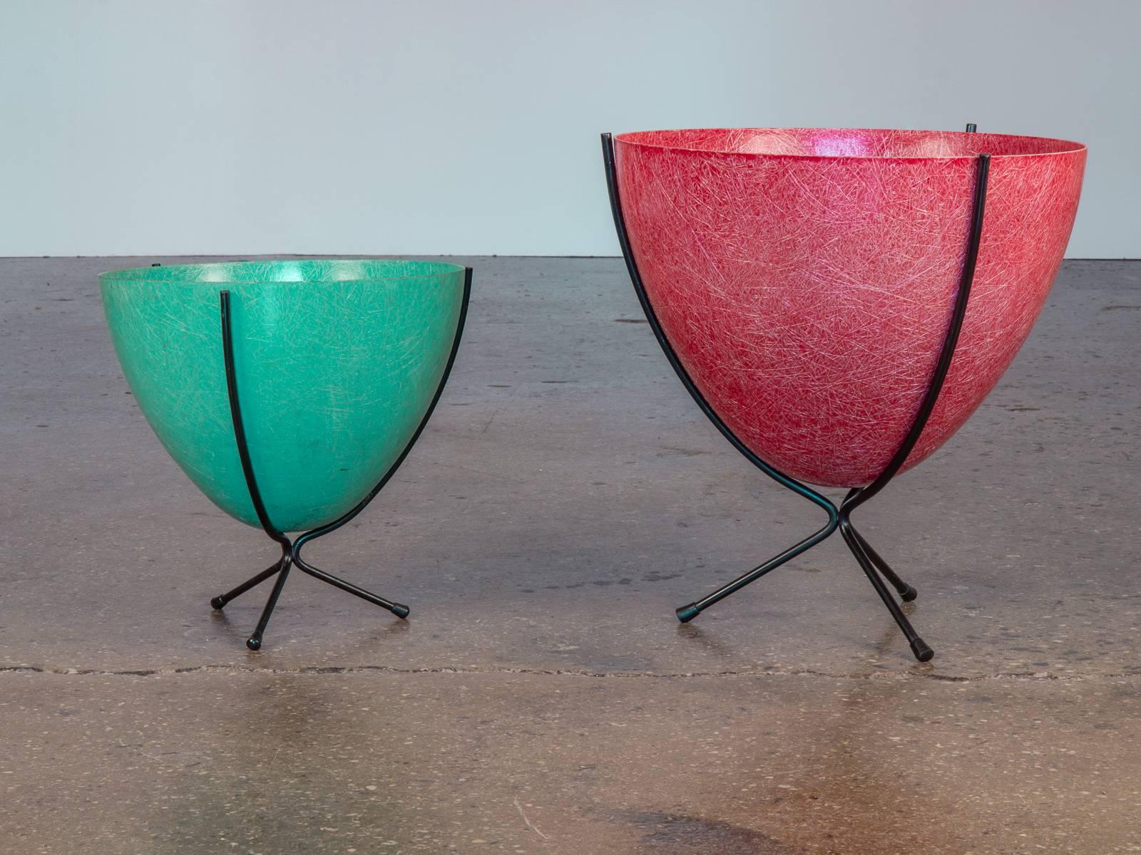 Beautiful, thready fiberglass planters date to the 1950s. Metal stands. Sold as a pair. The larger one is red, the smaller one is jade green. Both are in excellent condition with wear on the inside only. The label reads: 