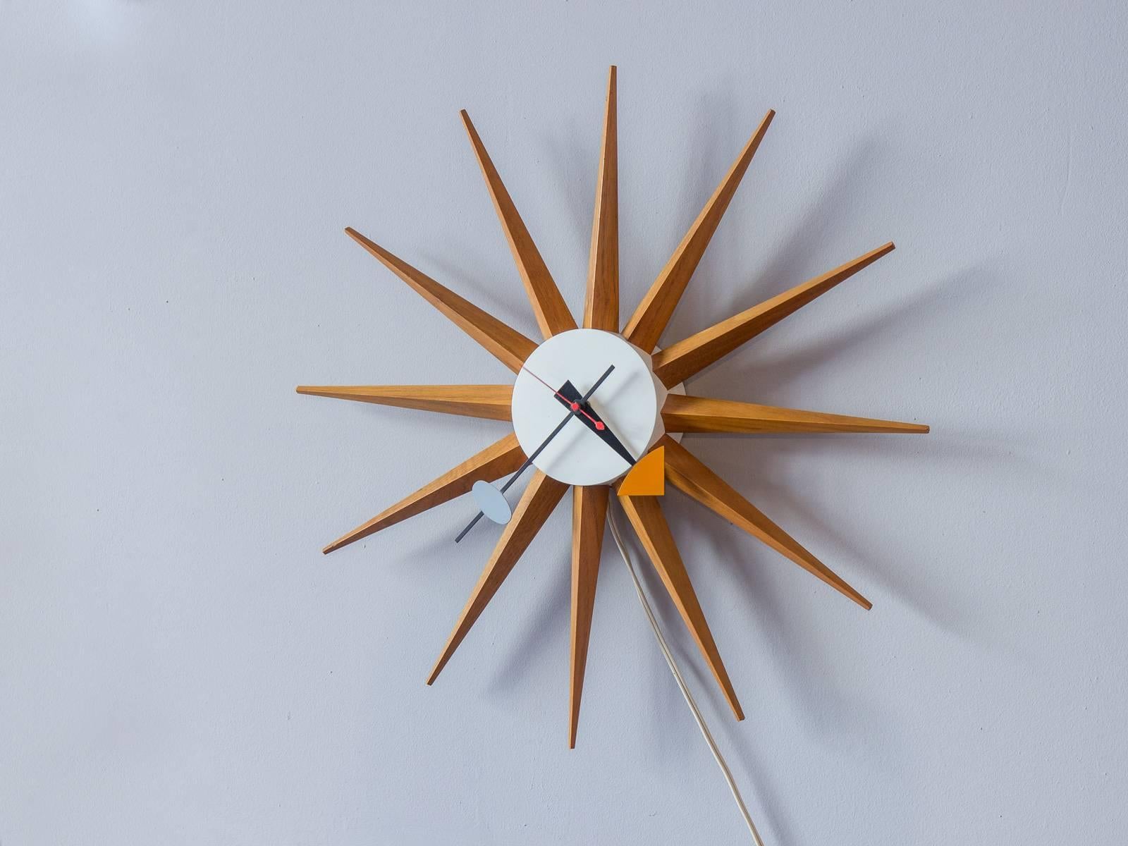 Gorgeous sunburst wall clock designed by George Nelson Associates for the Howard Miller Clock Co., circa 1949. The clock plugs in, has enameled hands, and is in excellent vintage condition.

18.5