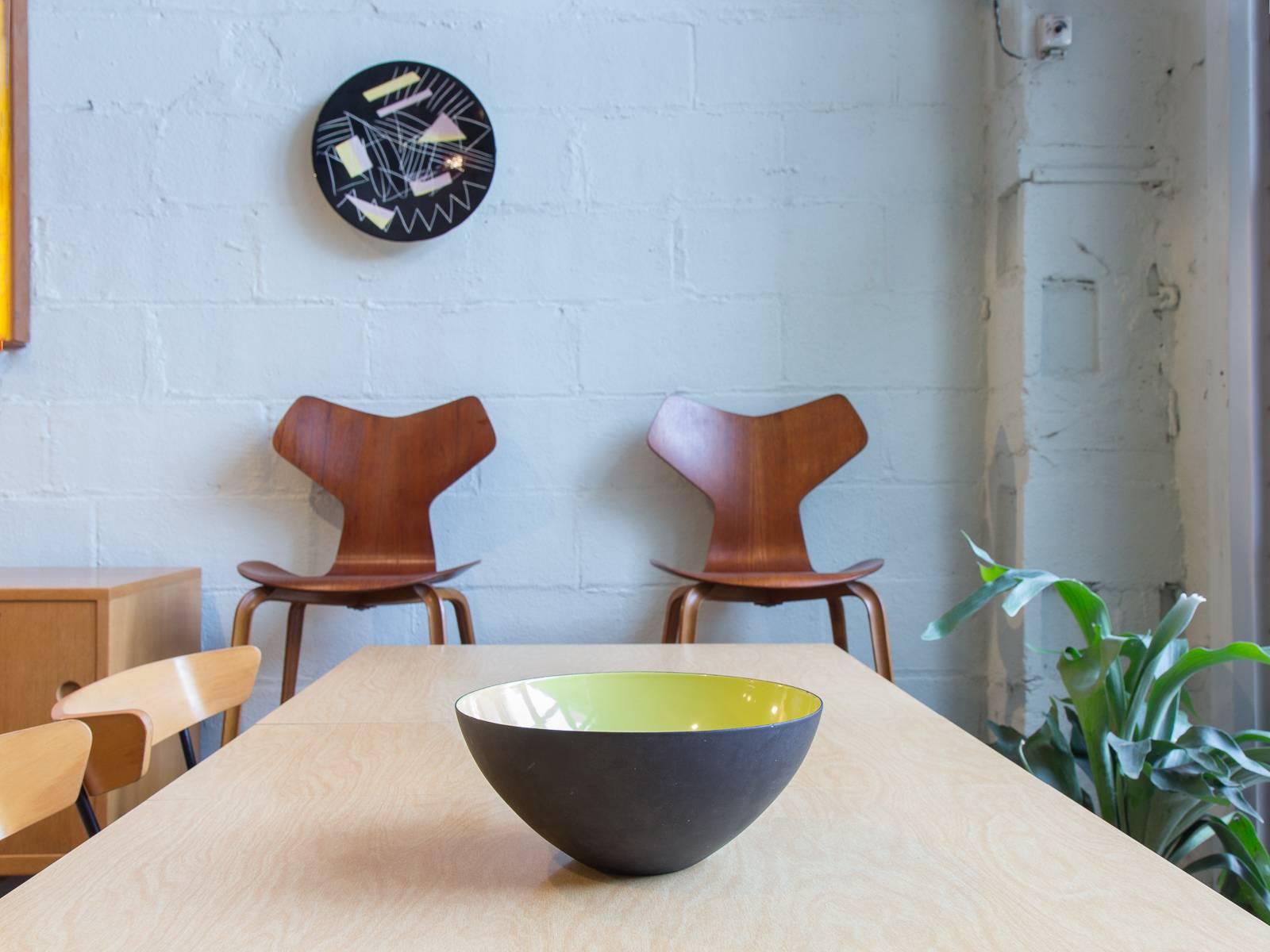 Large salad or serving bowl is in excellent vintage condition. Designed by Herbert Krenchel in the 1950s. Steel exterior and citron enameled interior. The color is a yellow-leaning chartreuse. Made in Denmark. Marked with the Krenit