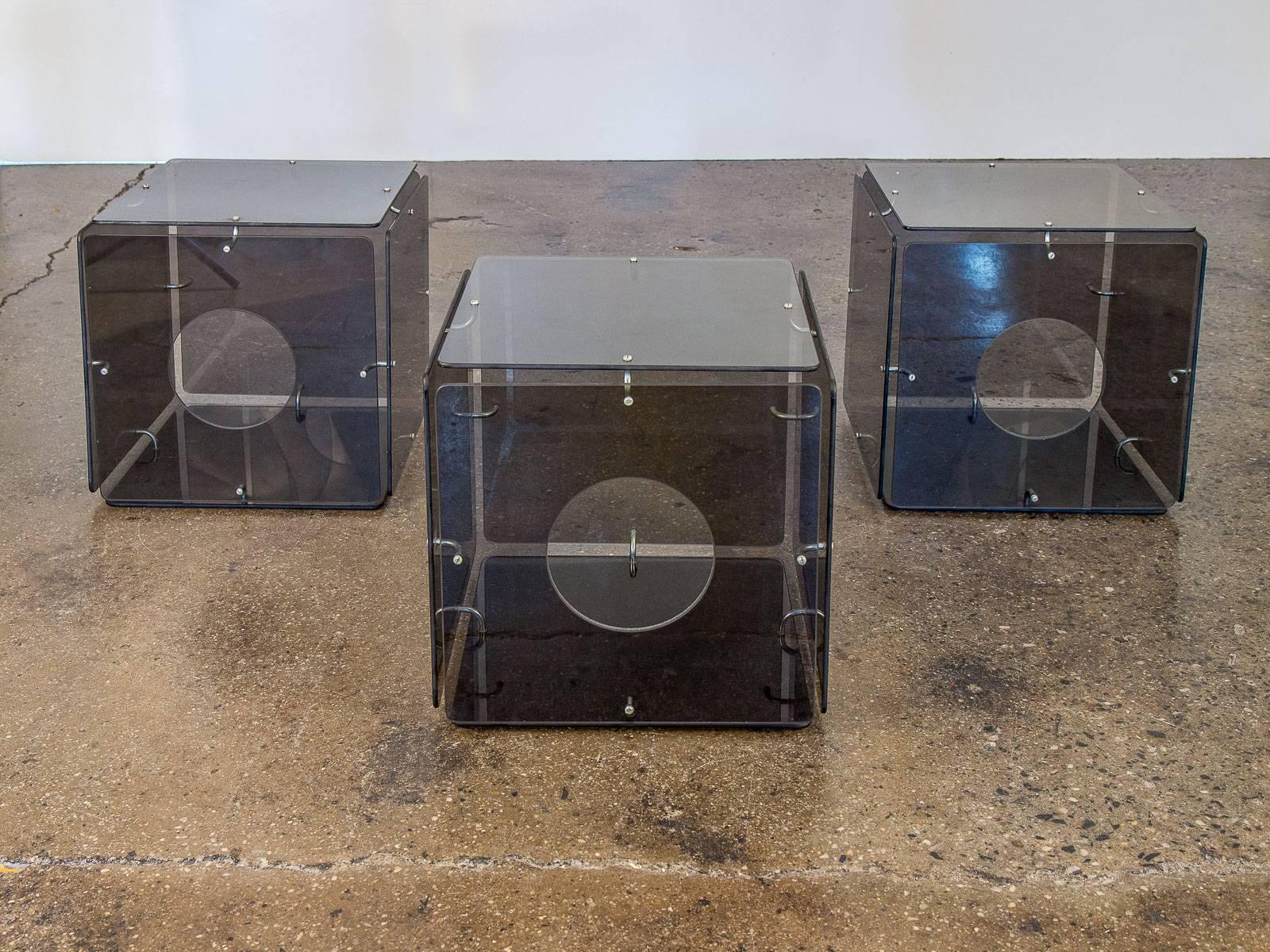 Three smoke glass cube tables by Gerald McCabe for Eon Furniture USA, 1963 smoke glass, aluminum. Six panels of smoked glass joined by Industrial aluminum brackets to form these minimal cube tables. Elegant spacing between each panel as well as the