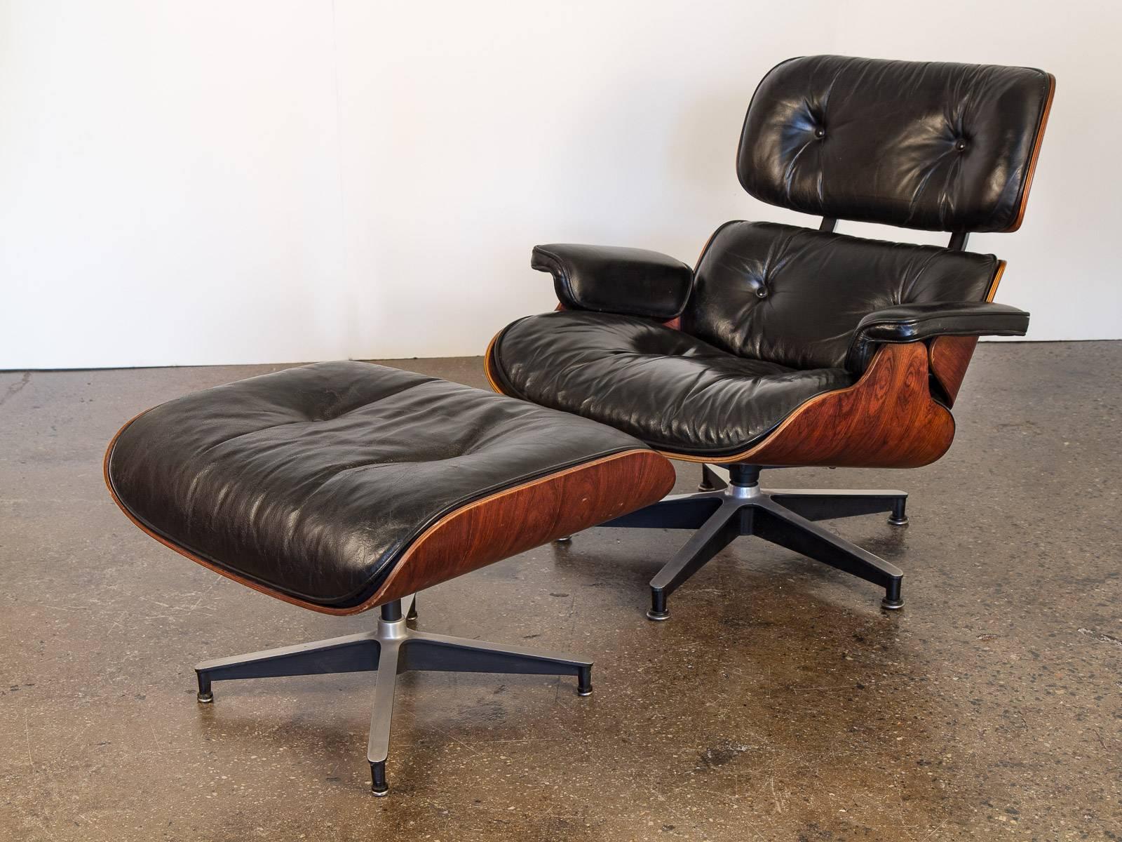 Iconic 670 Lounge Chair and 671 Ottoman designed by Charles and Ray Eames for Herman Miller. Lounge chair has all of its original black leather, with a beautiful patina. Left armrest has seen some wear, nothing unsightly. Both in overall wonderful