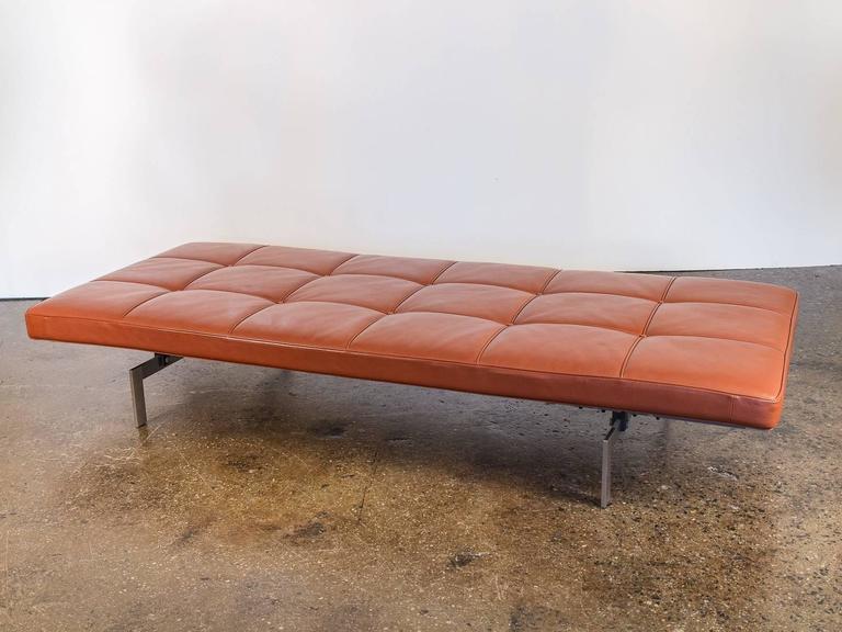 PK80 Daybed designed by Poul Kjaerholm manufactured by Fritz Hansen. This recent edition’s cognac cushion is slightly tufted with piping in a grid-section format, forming a glove-like sturdy resting place. Contrary to the black version, this rich