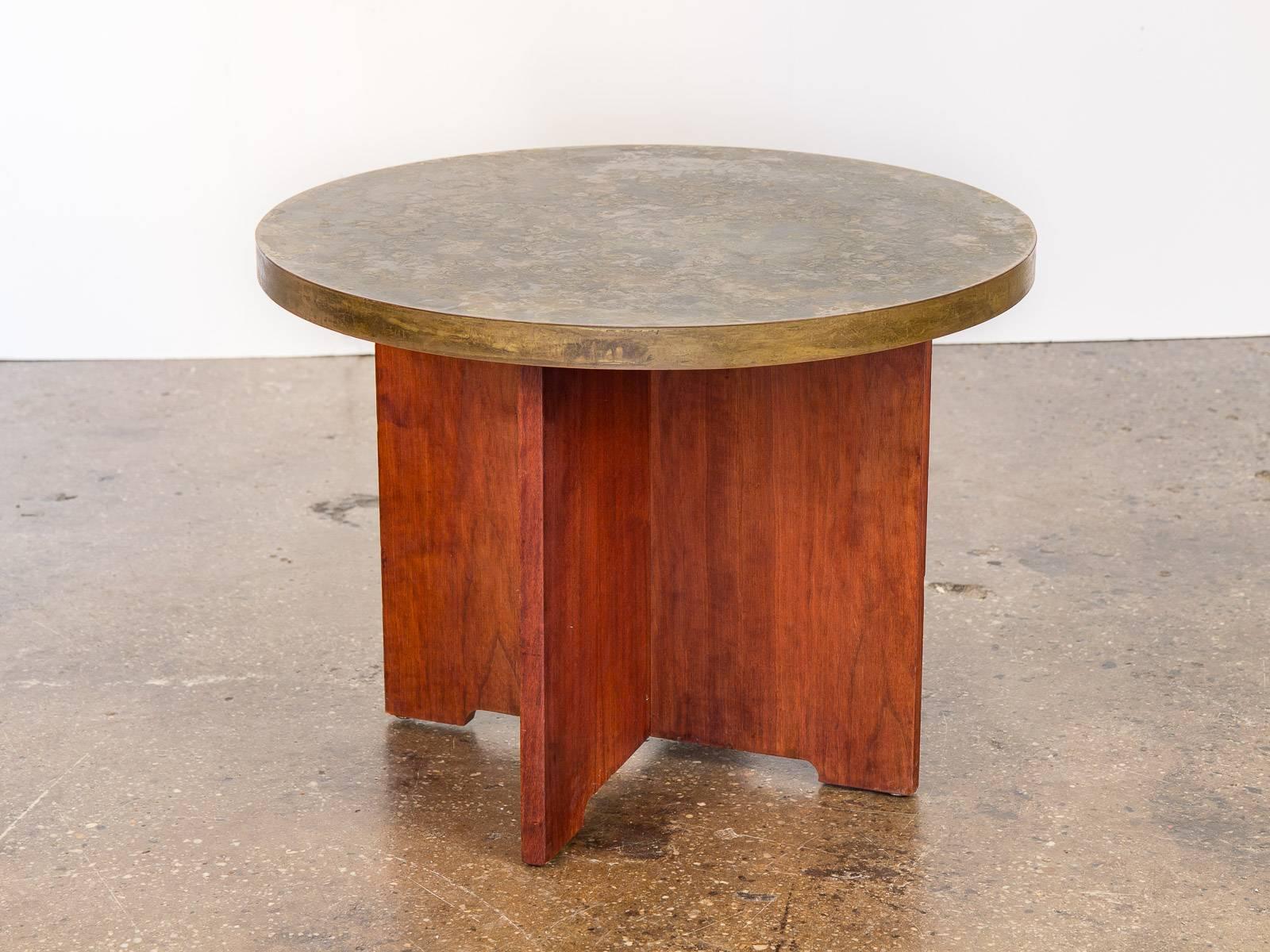 1960s acid-etched round side table in the style of Philip and Kelvin LaVerne. The acid-etched texture creates a lovely mottled finished surface which sits on a sturdy, cross lap-joint wooden base that is quite low to the ground. Table-top measures