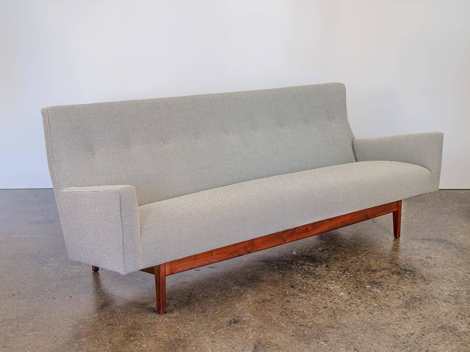 Scarce, highly sought after U-150 sofa designed by Jens Risom. This stylish robust sofa is newly upholstered in a beautiful Colline Kvadrat Maharam fabric. The moire texture of the fabric compliments the angular arms and jaunty curvature of the