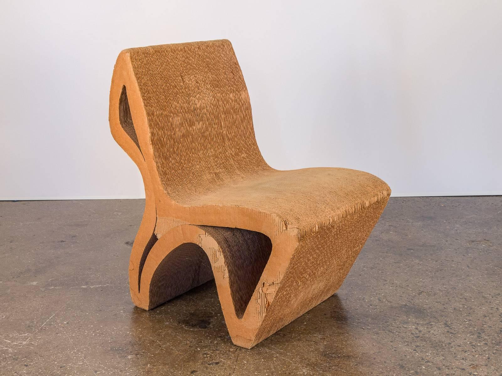 Unique, one-off vintage corrugated cardboard chair. Reminiscent of Frank Gehry’s cardboard Wiggle chair, this minimal design follows a sequential contour that demonstrates an intriguing profile at all angles. While worn, this chair is surprisingly
