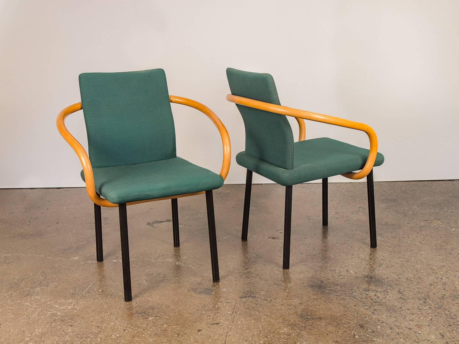Pair of Ettore Sottsass Mandarin chairs for Knoll Studio designed in 1986. Steel frame and legs sustain the forest green cushions and wrapping cylindrical wooden arms. Fabric is worn but presentable. A reminder of the Memphis founder’s