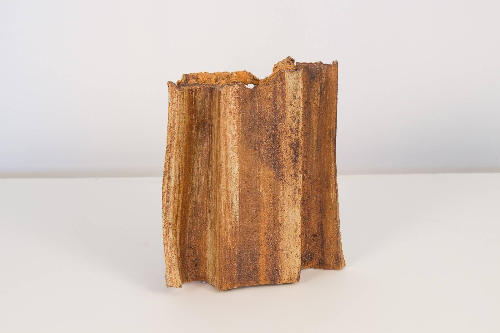 Abstract ceramic sculpture by unknown artist. Alluding to a fragmented steel beam of refuse, this dystopic work of art will compliment a room with it's coarse texture and weathered form. Plastic padding affixed to the base of the sculpture for