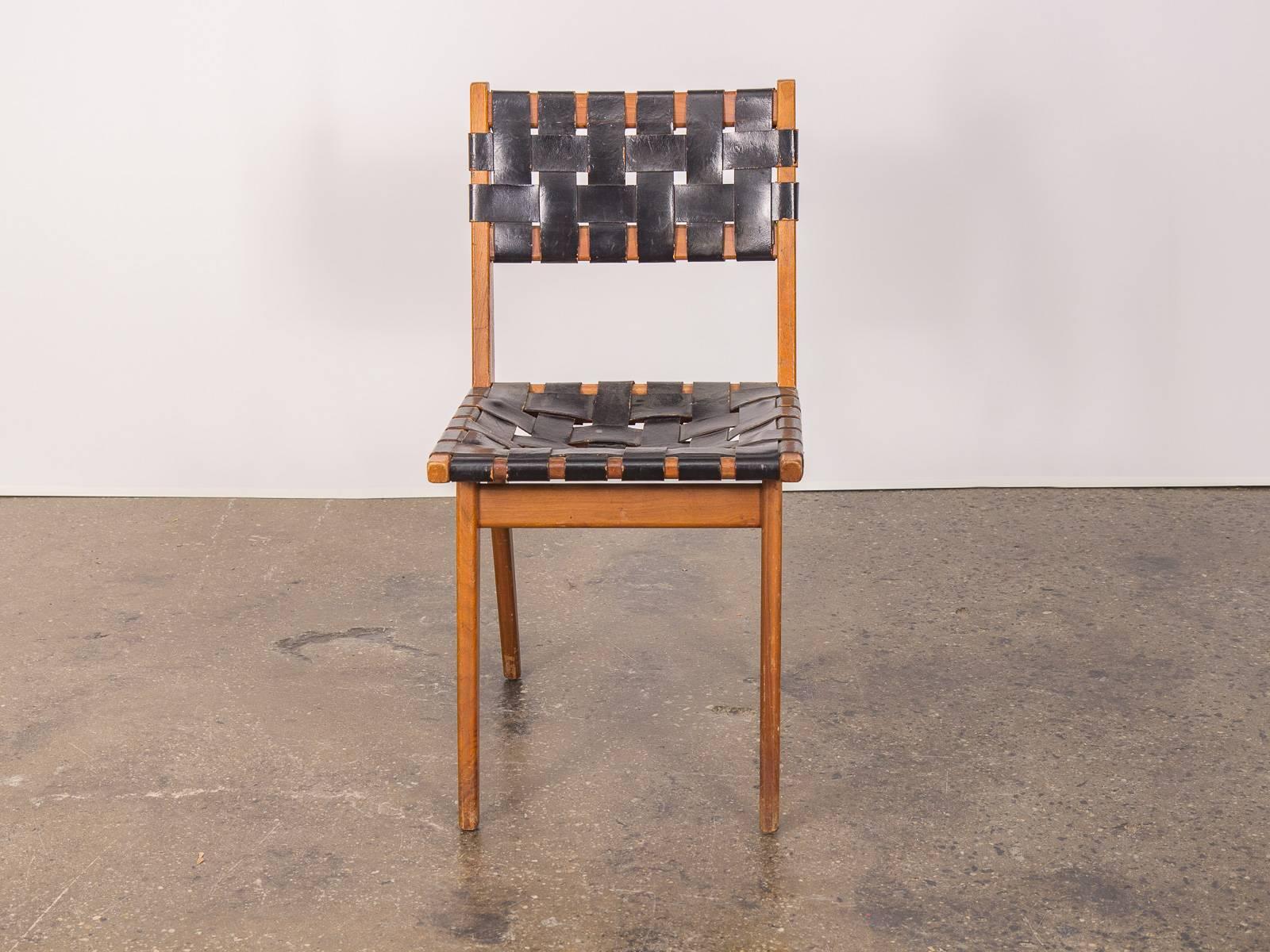 Vintage teak side chair with woven black leather in the style of Jens Risom. This possibly late 1940s chair has a wonderful, age-appropriate distressed wear which contributes to its individual flavor and character. A lightweight, adaptable accent