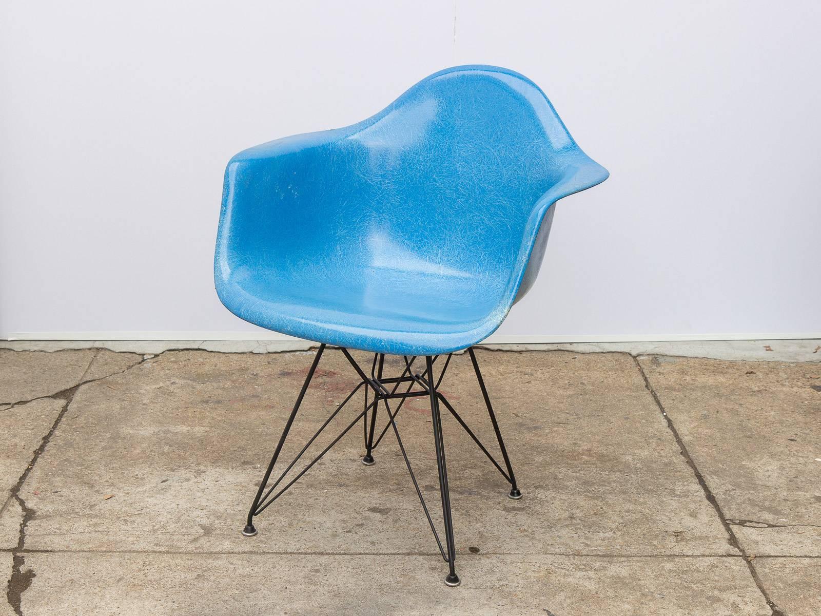 Set of four Classic Charles and Ray Eames molded fiberglass armchair in blue on the black eiffel base for Herman Miller. Original finish with distinct thread texture. Herman Miller stamp on the underside. Other base styles available, inquire within.