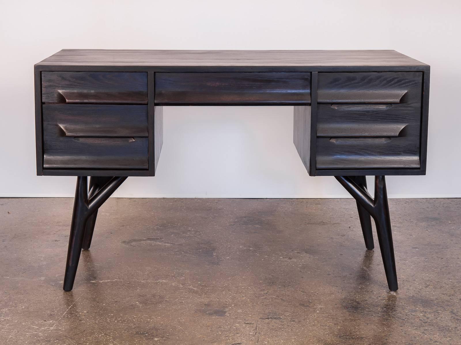 Beautiful 1950s ebonized oak desk attributed to Jack Van Der Molen for Vanleigh. The sculptural form of this sleek desk makes it a highly functional, statement piece. Finish is lustrous, yet allows the distinct wood grain to show through. The desk