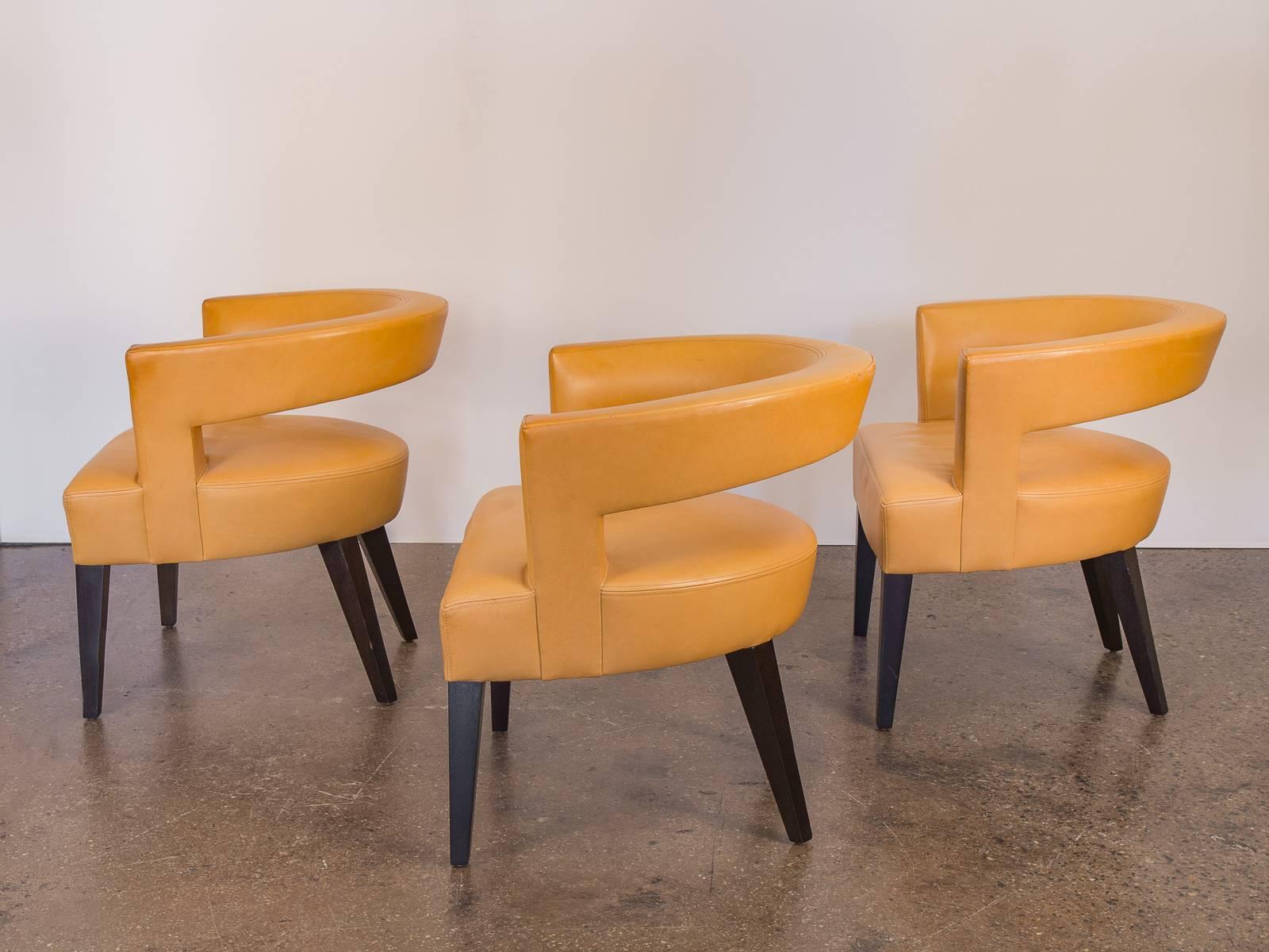 Three, contemporary leather ringback chairs on solid cherry, ebonized legs by Dakota Jackson. Striking set of chairs for any seating area. These chairs are in good condition—the double-stitched, buttery canary-mustard leather has a fine patina with