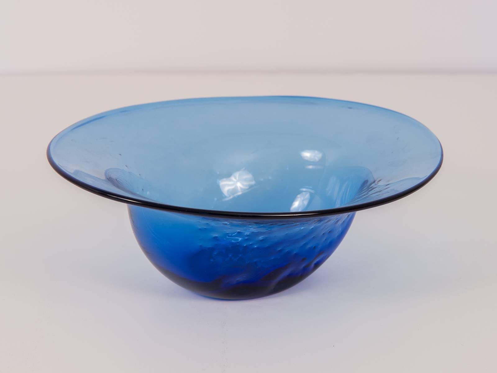 Vintage wide-rimmed blue glass bowl by American glass company Blenko. Lovely centerpiece bowl for modern presentation. Handblown glass design has dimple-like indentations, creating a charming texture throughout the glass. A few faint scratches on
