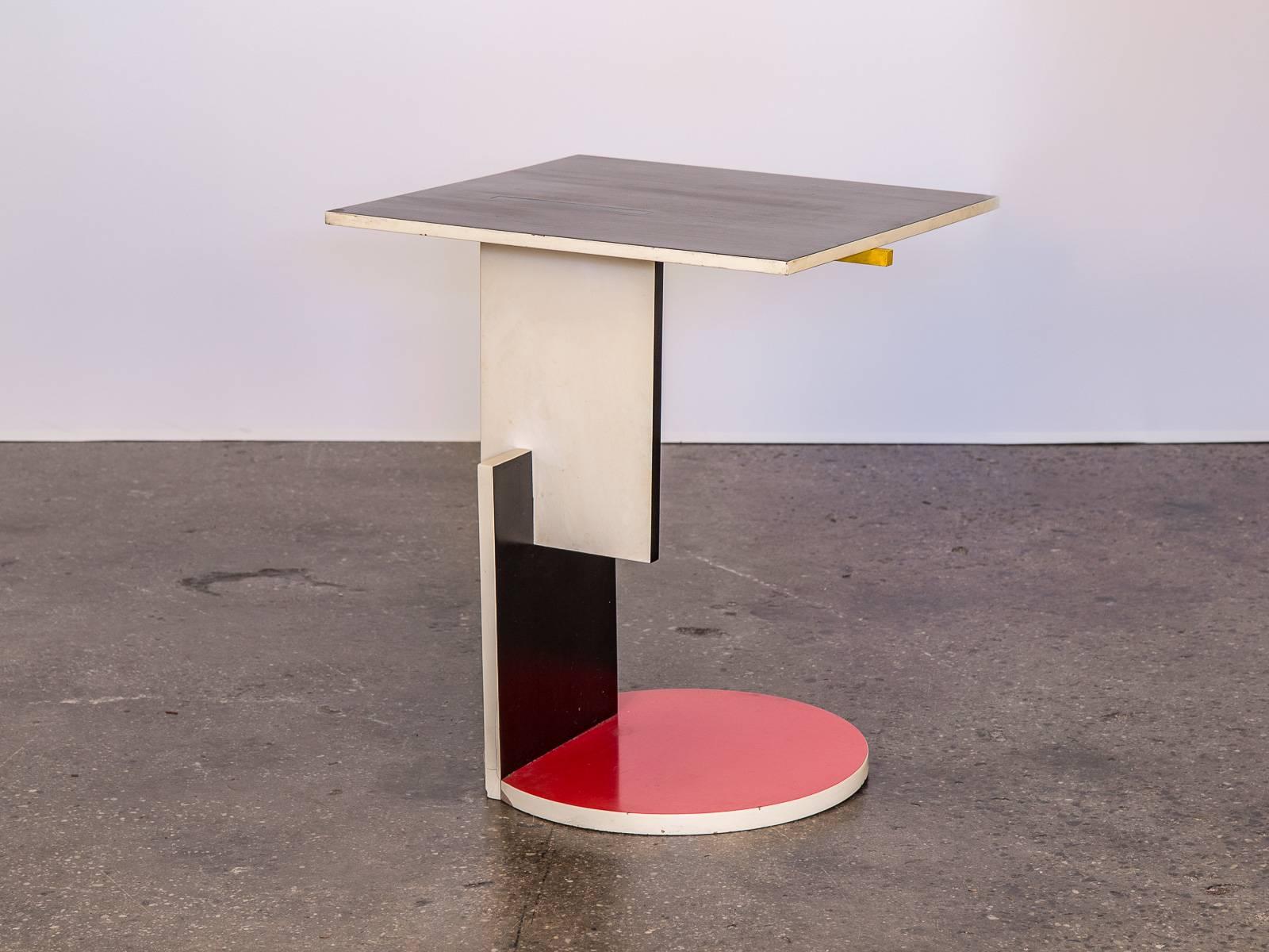 Asymmetrical table by Dutch designer and architect Gerrit Rietveld. Created alongside his 1924 Schroeder House, this side table follows the primary color palate and geometric cubist form of De Stijl design. Our table is about thirty years old, one