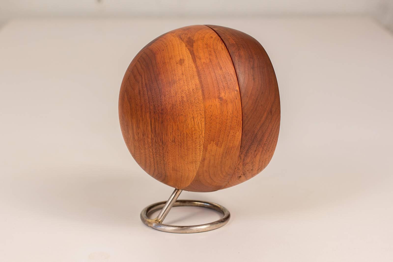 Scarce, Chronopak desk clock designed by George Nelson for Howard Miller. Spherical walnut body has a pretty wood selection, and floating chrome base adorns an attractive, faint patina. This clock has been conveniently retrofitted and operates on