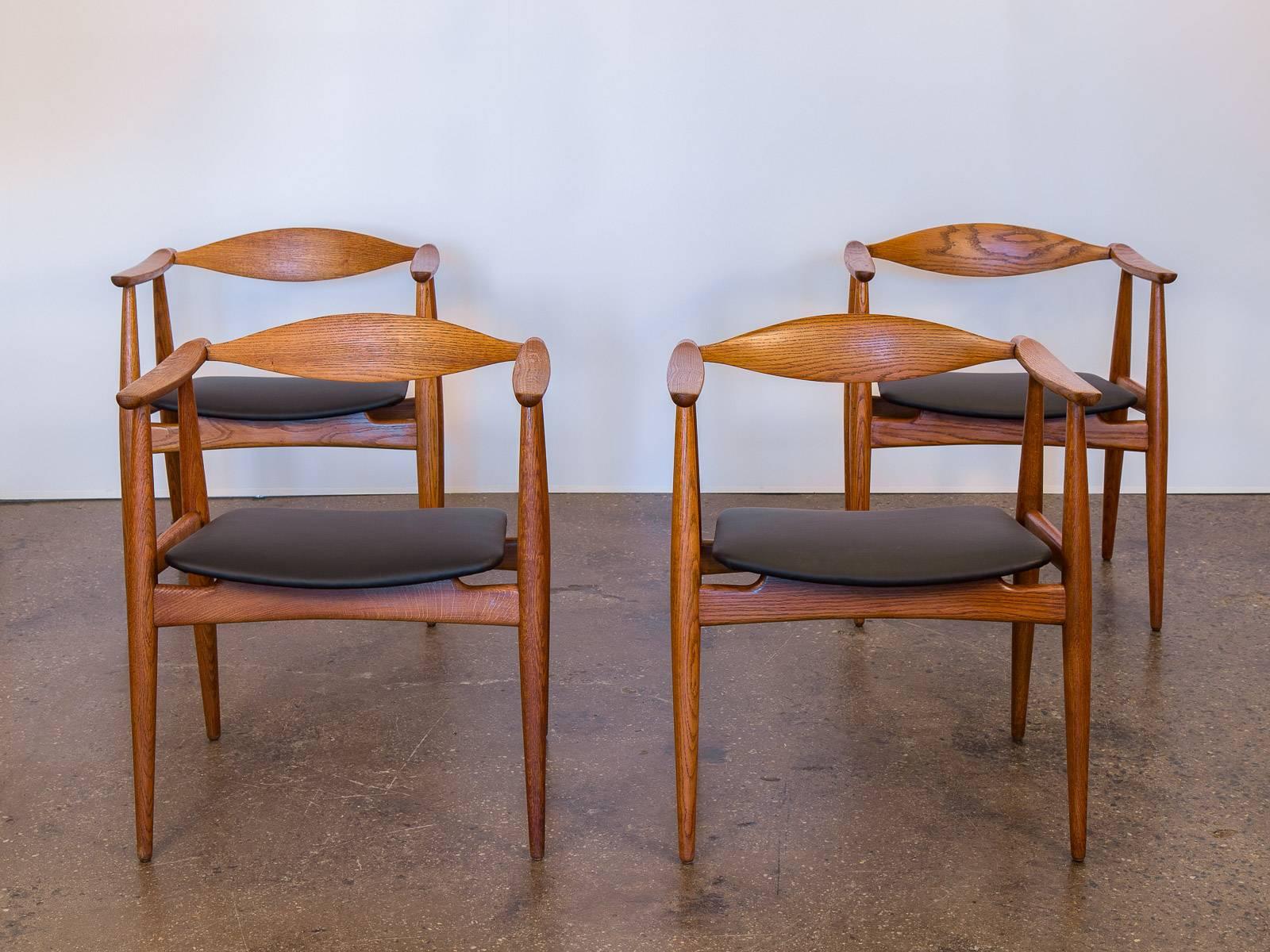 Scarce set of four CH-35 Wegner Chairs for Carl Hansen & Son. Original owner purchased these out-of-production chairs in the 1960s. All chairs are marked on the underside and in impeccable condition. Armchairs are fully restored; the floating seats