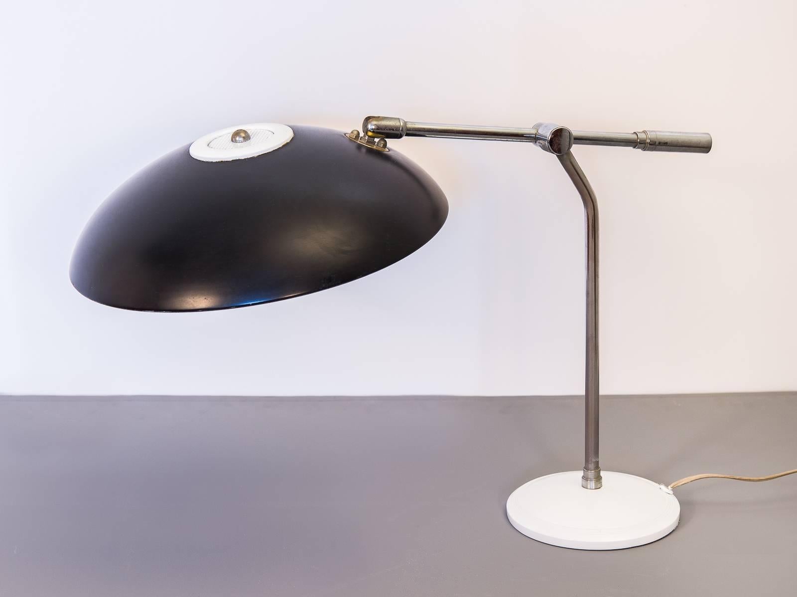 Very scarce, articulating table lamp designed by Gerald Thurston for Lightolier. A fine office companion. This vintage lamp has minimal wear and is in perfect working condition. Sleek, articulating chrome arm controls the shade's height and angle.