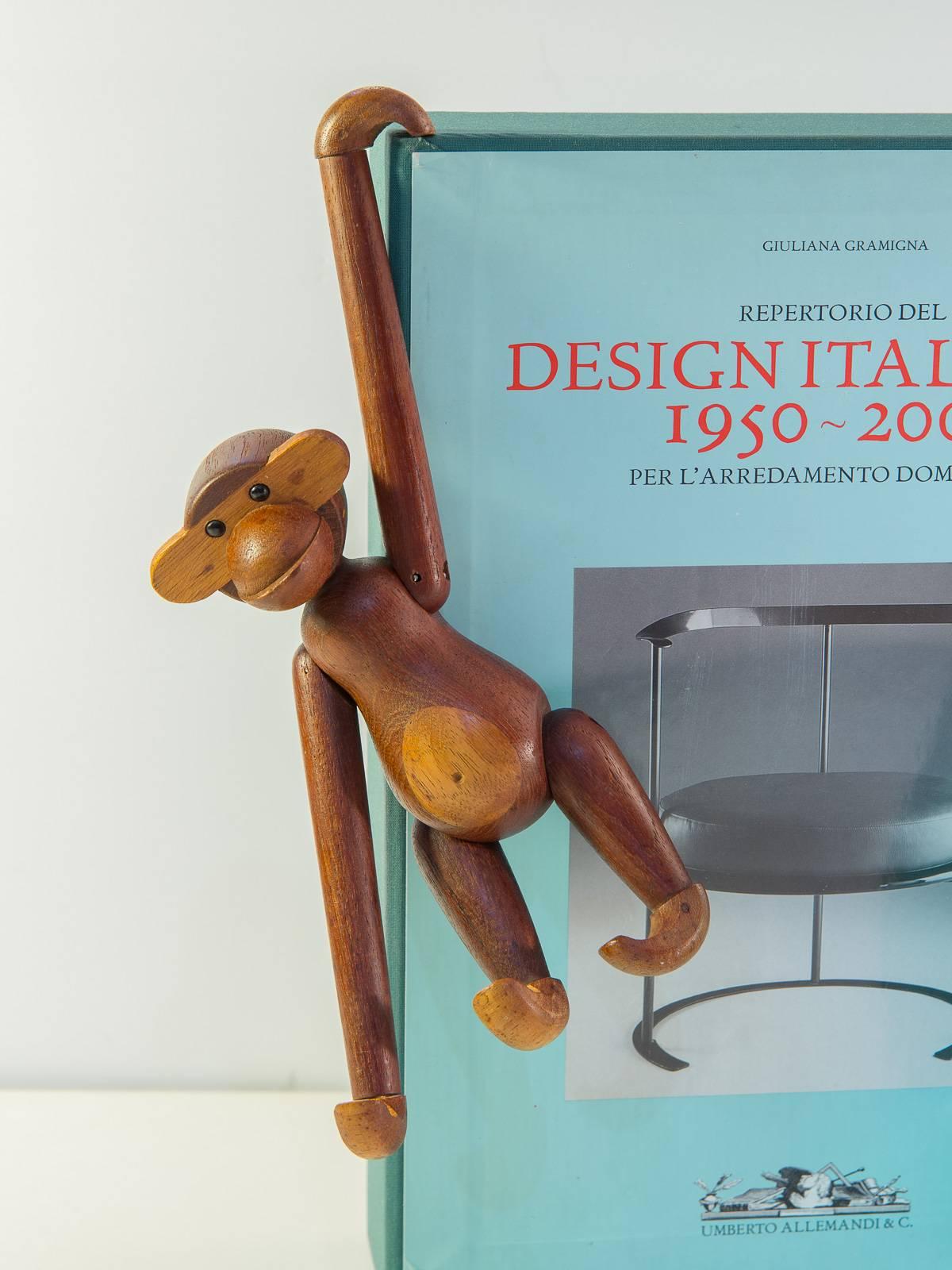 We have two vintage Kay Bojesen wooden toy monkeys. Designed in 1951, this smart toy is made of thirty-one carved pieces. The toy is durable, with a moveable form for hands at play, and the contrasting wood tonality demarcates form and expression. A
