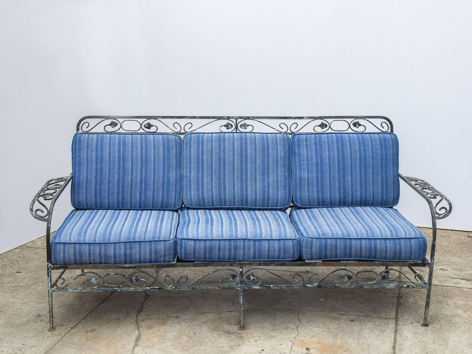 Vintage Salterini patio sofa and armchairs. This is where cabin-modern meets the English country. Capri blue-striped upholstery is from the 1970s, and has a nice age-appropriate wear. Serviceable upon request. Cushions are sturdy and robust due to
