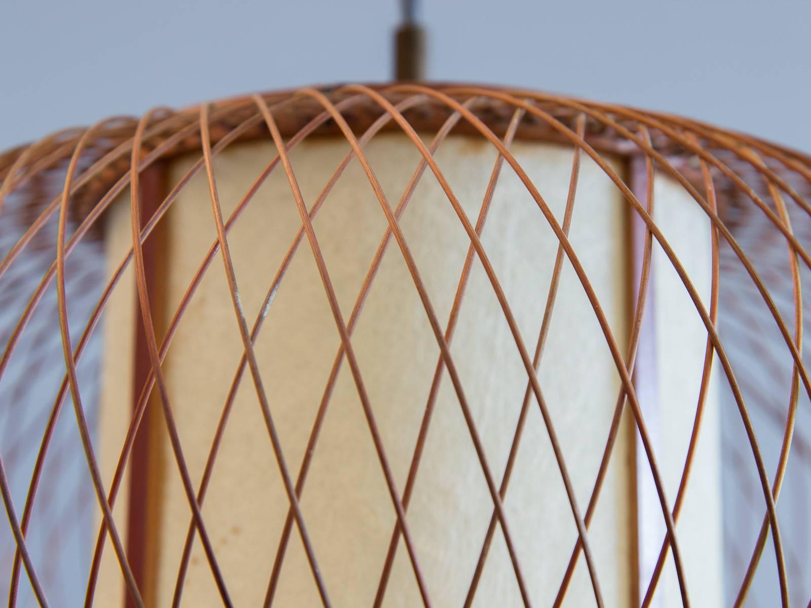Quietly sophisticated, Japanese woven pendant light. In very good condition and works perfectly. Delicately woven bamboo contrasts the lightly textured, cylindrical cream paper shade within. Elegantly crafted lighting choice. 1960s, made in Japan.
