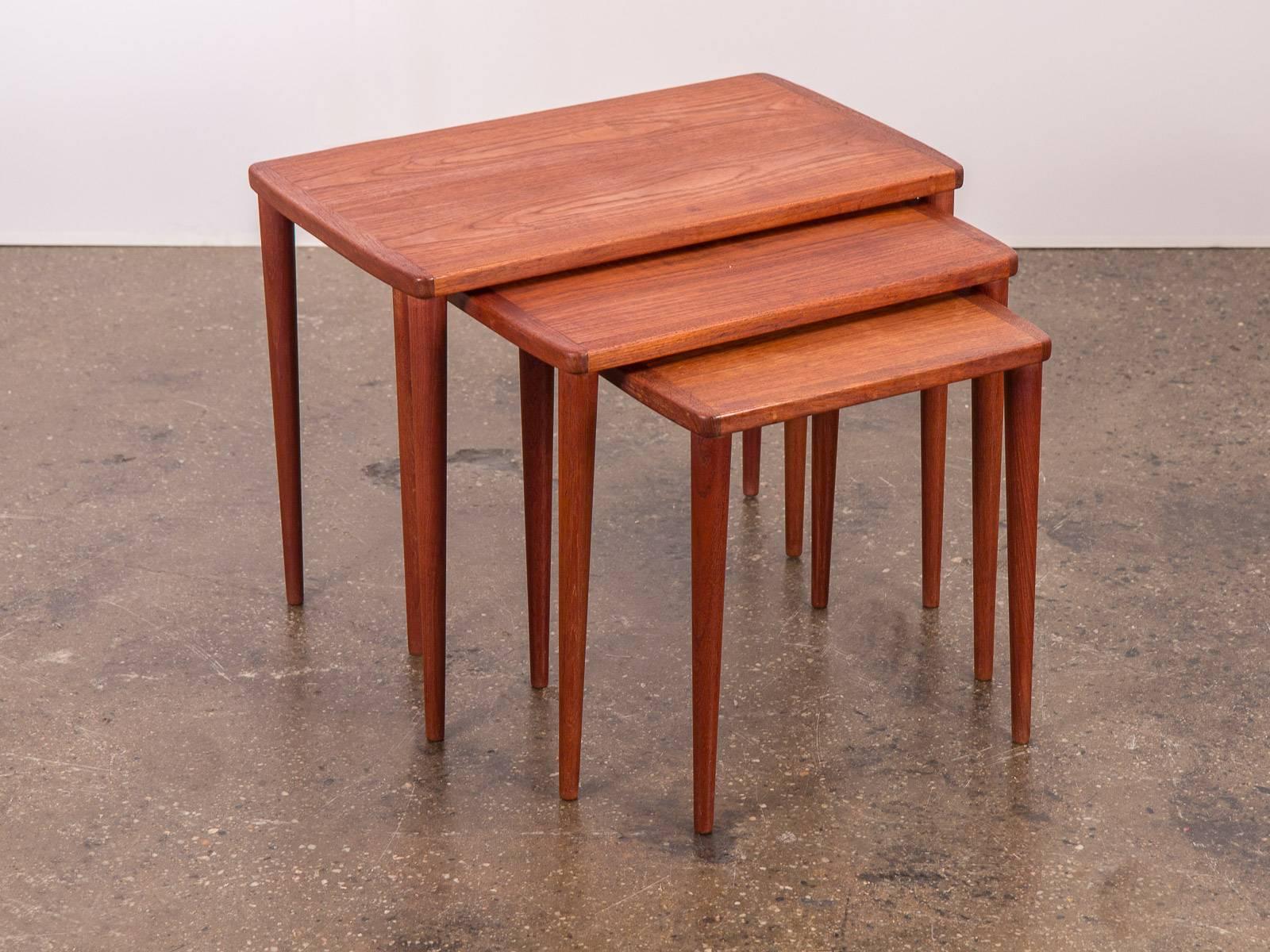 Scandinavian Modern teak nesting tables. Rich, beautiful teak wood selection with tapered legs. Excellent vintage condition. A handsome set of finely crafted tables from the 1960s. Made in Sweden.