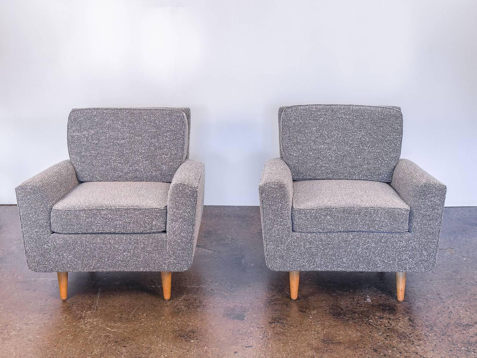 Very scarce, early 1950s Florence Knoll lounge chairs for Knoll International. Substantial cushions are irresistibly deep and supremely cozy. Our examples are newly upholstered in a plush bouclé, slate-gray Maharam Pebble Wool that is structured yet