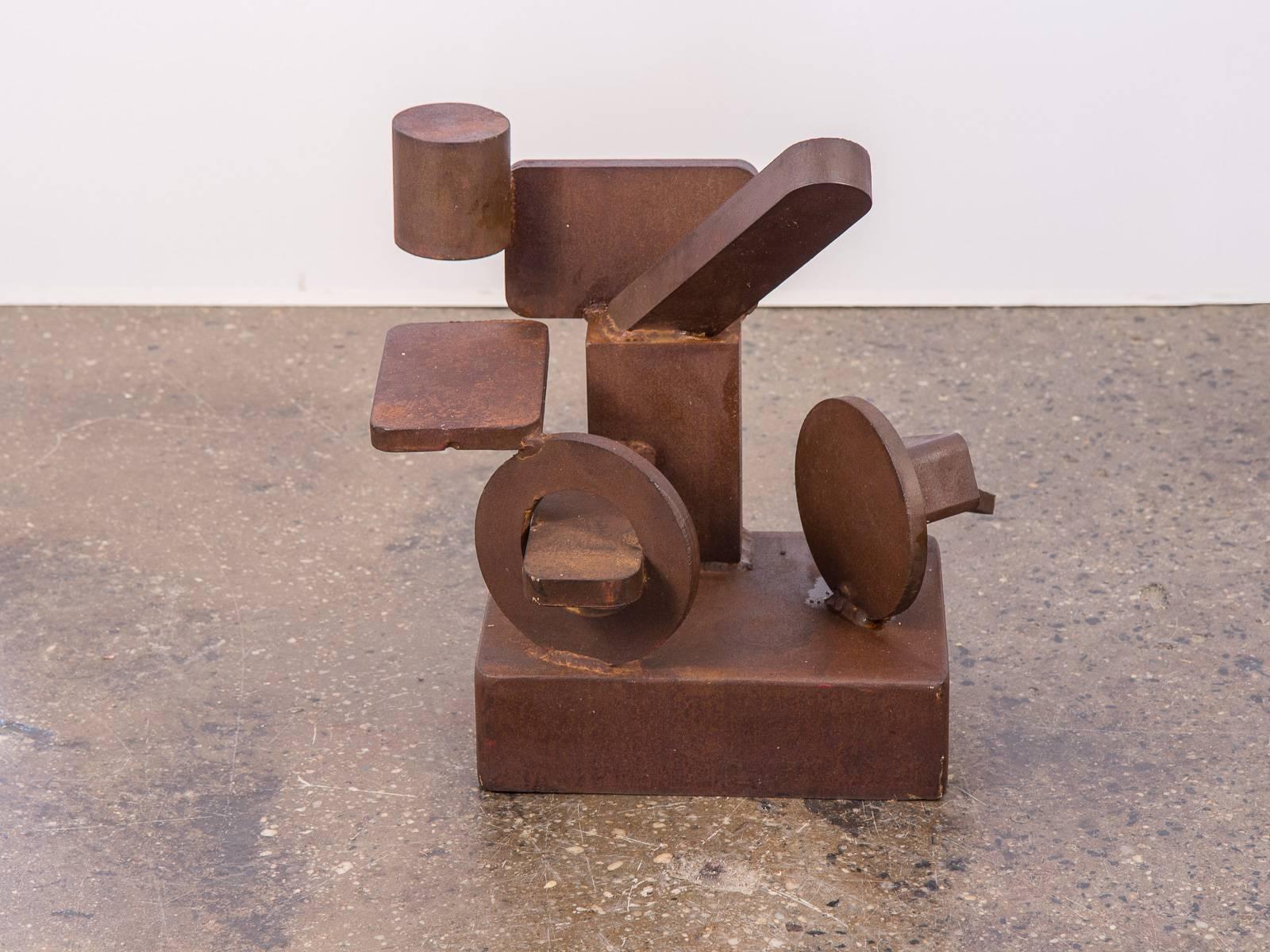 Abstract, 1970s cast steel sculpture. In the style of David Smith. This scale model form is comprised of geometric elements solidly welded to a hefty base. Possibly used as a mock-up for a monumental work. Circles, cylinders, and rectangles float in