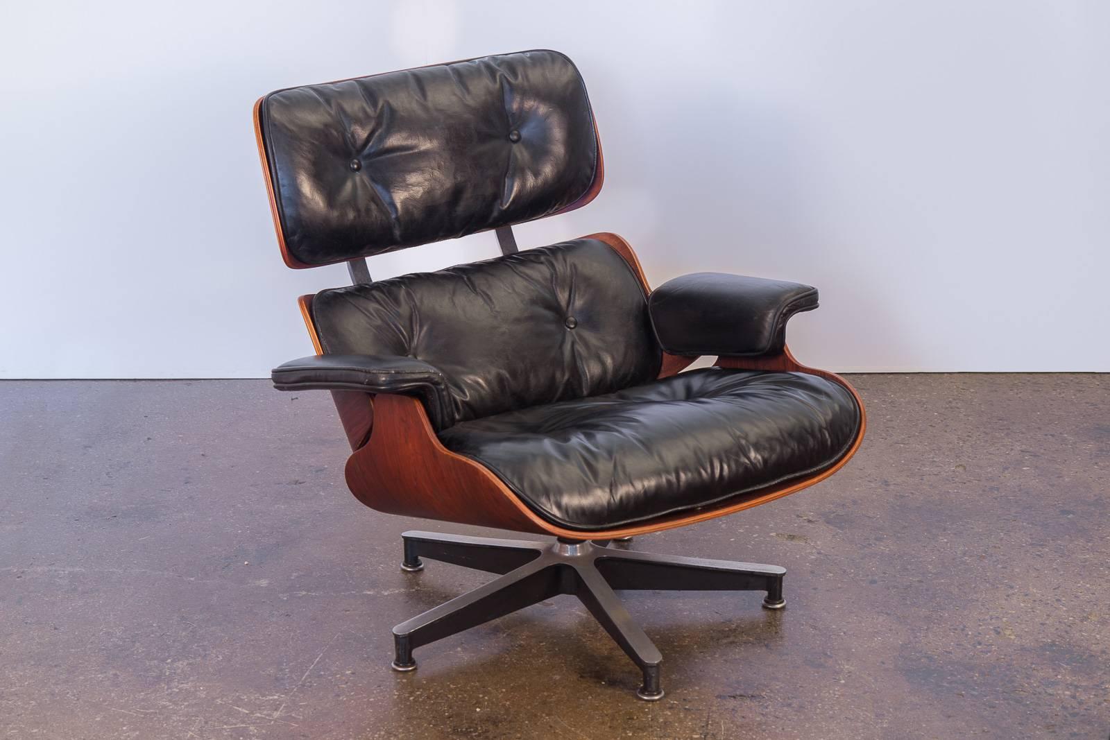 Vintage 670 Eames lounge chair and matching 671 ottoman by Charles and Ray Eames for Herman Miller. A supremely cozy lounge chair. Original leather has age-appropriate wear but is pliable and soft. Visible crazing in the armrests and back cushions.