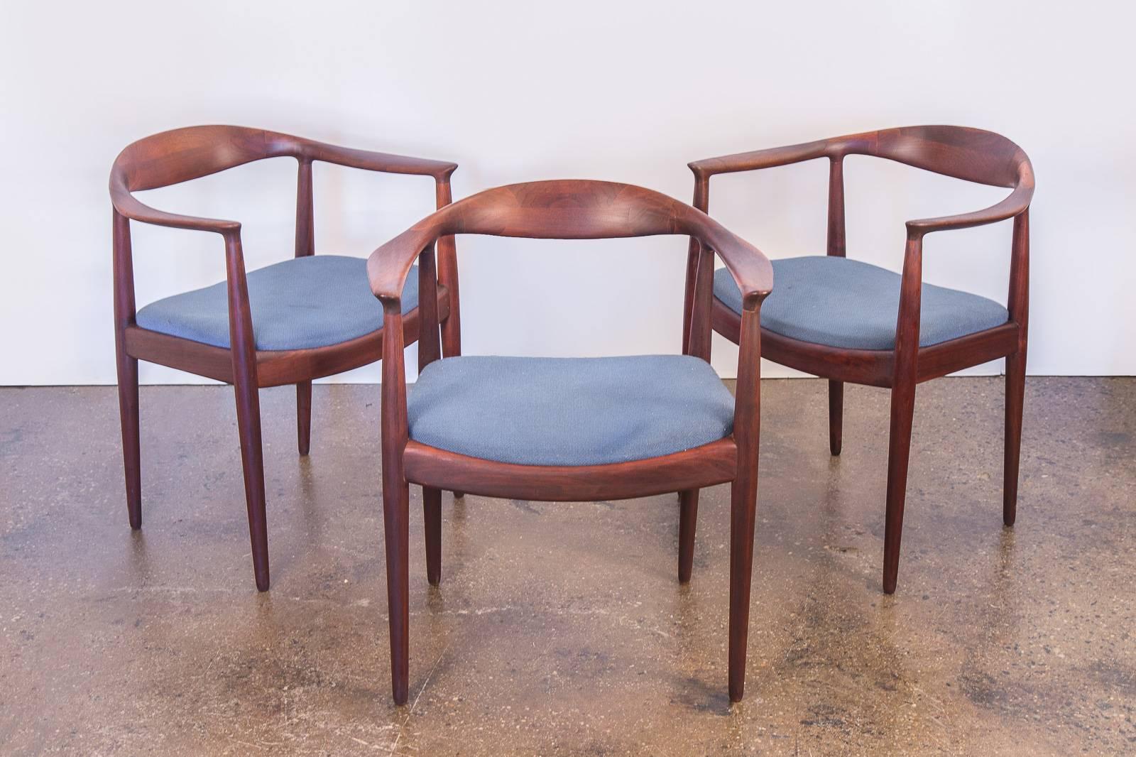 Set of six dining armchairs for Edward Axel Roffman Associates. An attractive set in the likeness of Hans Wegner's iconic Round chair. Sculpted walnut and stained wooden frames are elegant and sturdy. All chairs have varying degrees of