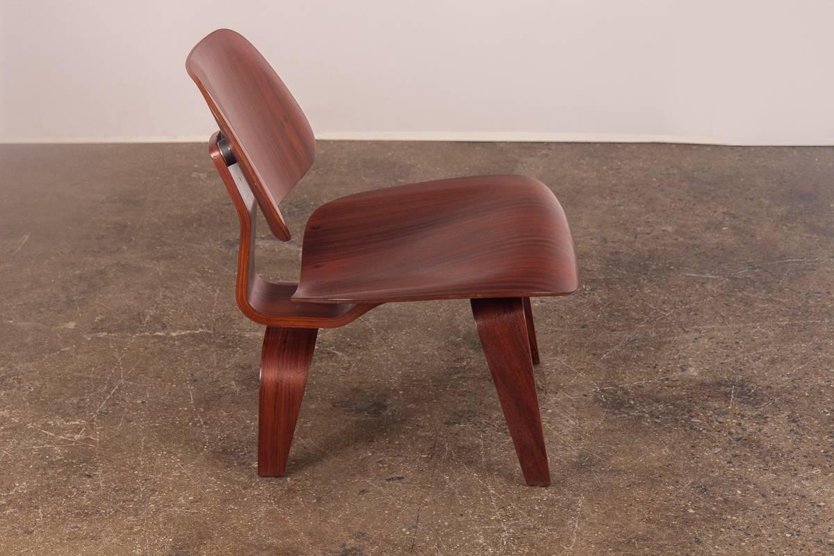 An Eames collector's Holy Grail, the rosewood pre-production LCW. Designed by Charles Eames in 1945-1946 and manufactured briefly by the early Evans Products Co. Seat back and underside are shown with the original Dual circular shock mounts and