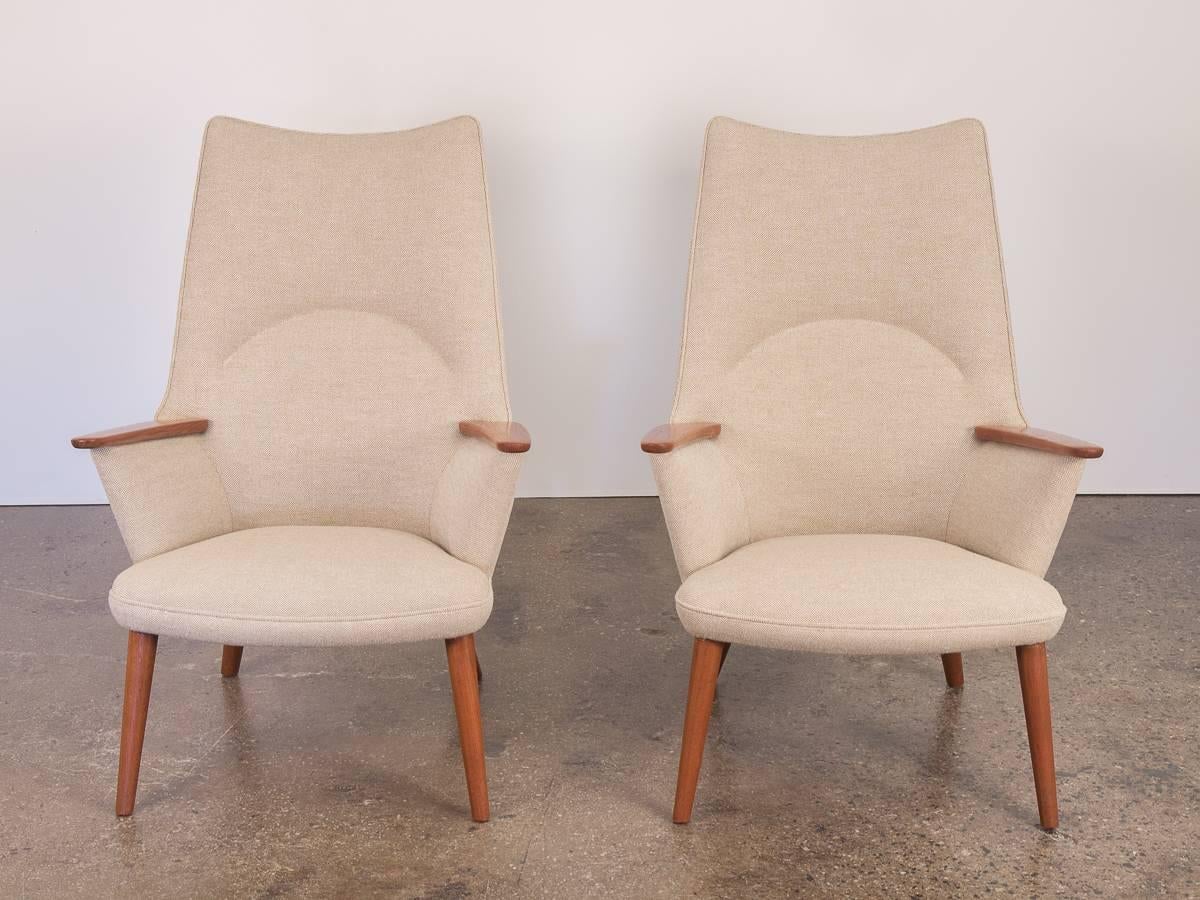 Scarce pair of Hans J. Wegner AP-27 lounge chairs for A.P. Stolen designed in 1954. Impeccable condition and supremely comfortable. These elegant, high-back armchairs are newly upholstered in a beautiful, earthy Hallingdal Kvadrat Maharam fabric