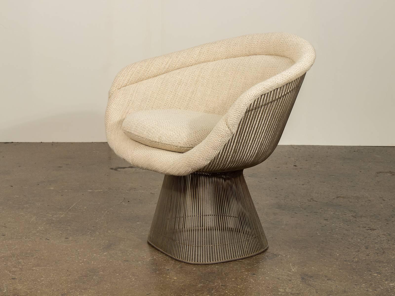 Part of the Platner Collection for Knoll in 1966, Warren Platner's lounge chair combines a soft, inviting seat with an innovative base formed of steel wire rods. Meticulously upholstered in textural cream wool. Matching Platner stool listed