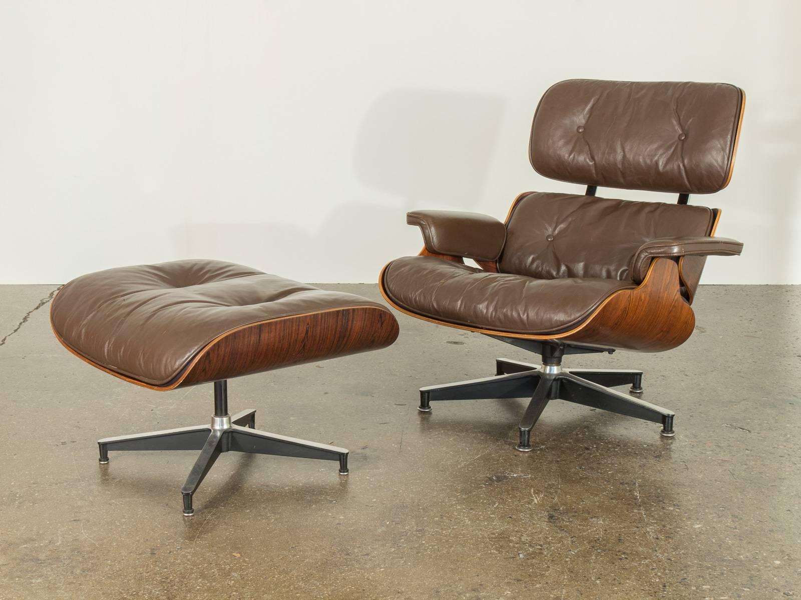 1964 Eames 670 lounge chair and ottoman in excellent vintage condition. Designed by Charles and Ray Eames for Herman Miller. Beautiful rosewood shell and soft brown leather cushions. Marked with Herman Miller medallion.

32.75