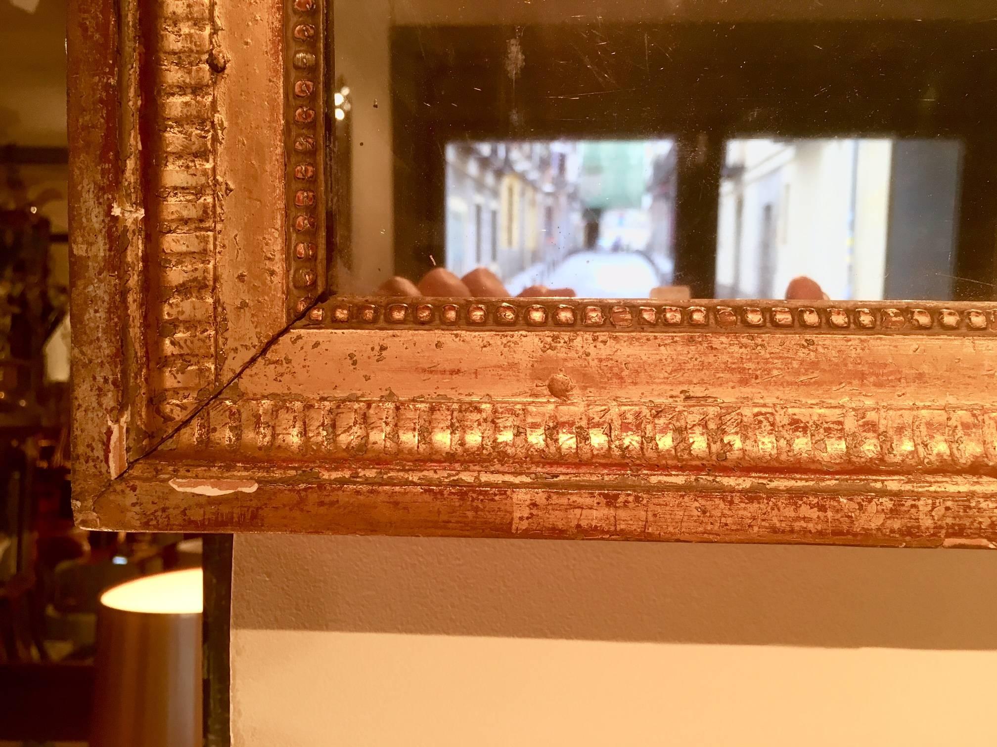 Louis XVI period giltwood mirror, 18th century with two-part mercury plate (original).
The gilded frame bordered in acanthus leaf decoration.