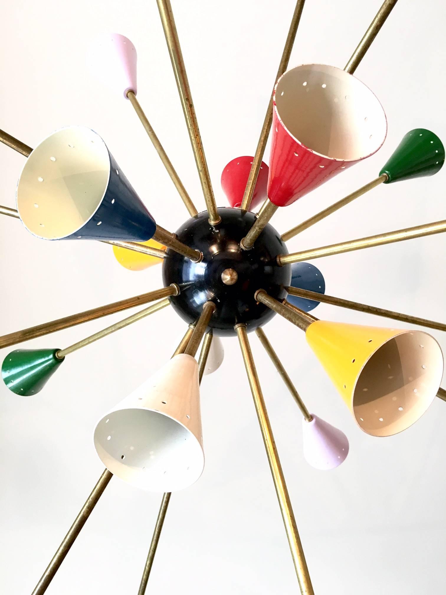 Colorful pair authentic Sputnik chandelier in the style Stilnovo from 1950.
Brass construction with 24 arms and colored cone are an authentic chandelier which has been cleaned, original painted and patina.