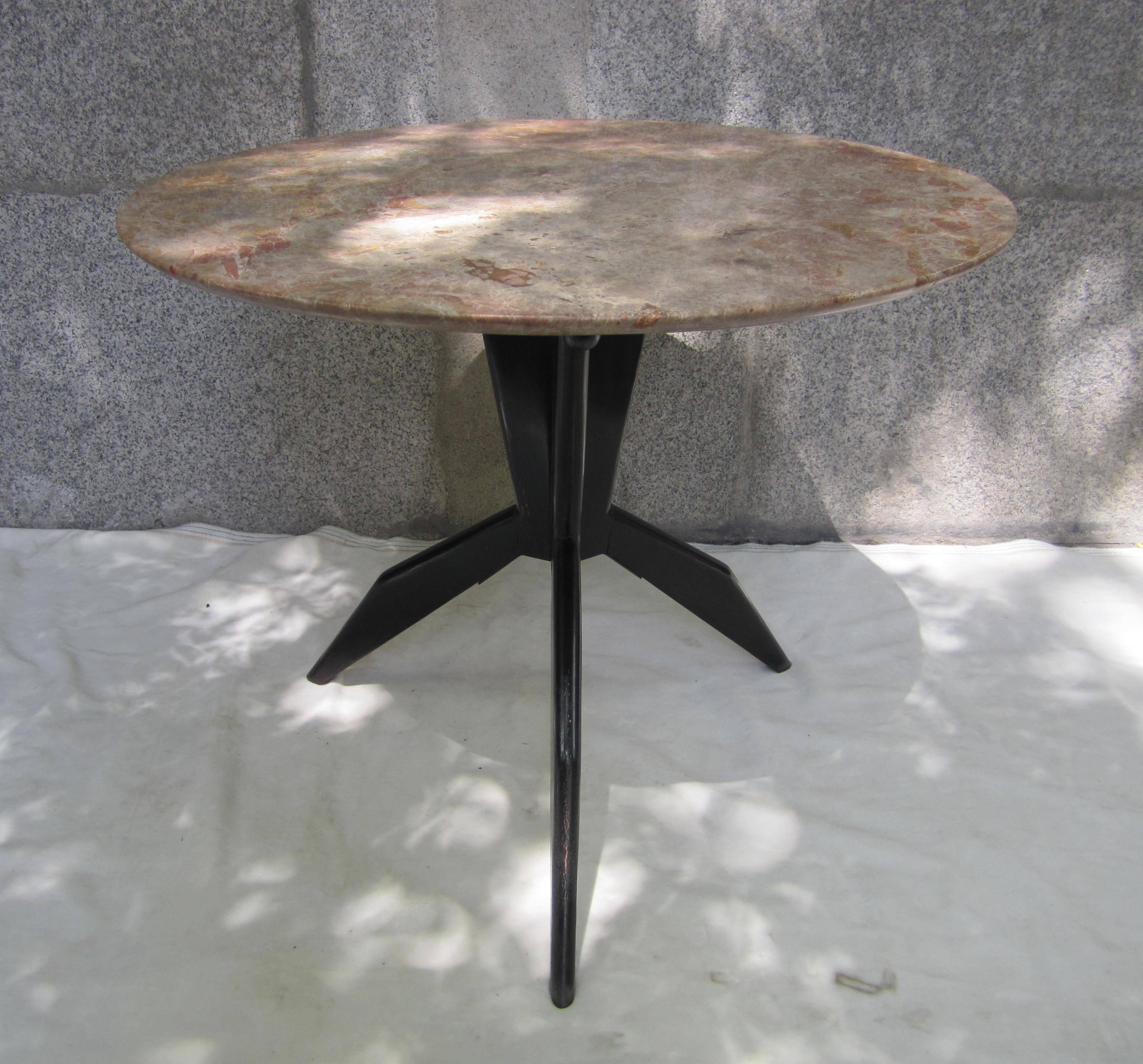 A marble and ebonished wood round table, France, 1960.