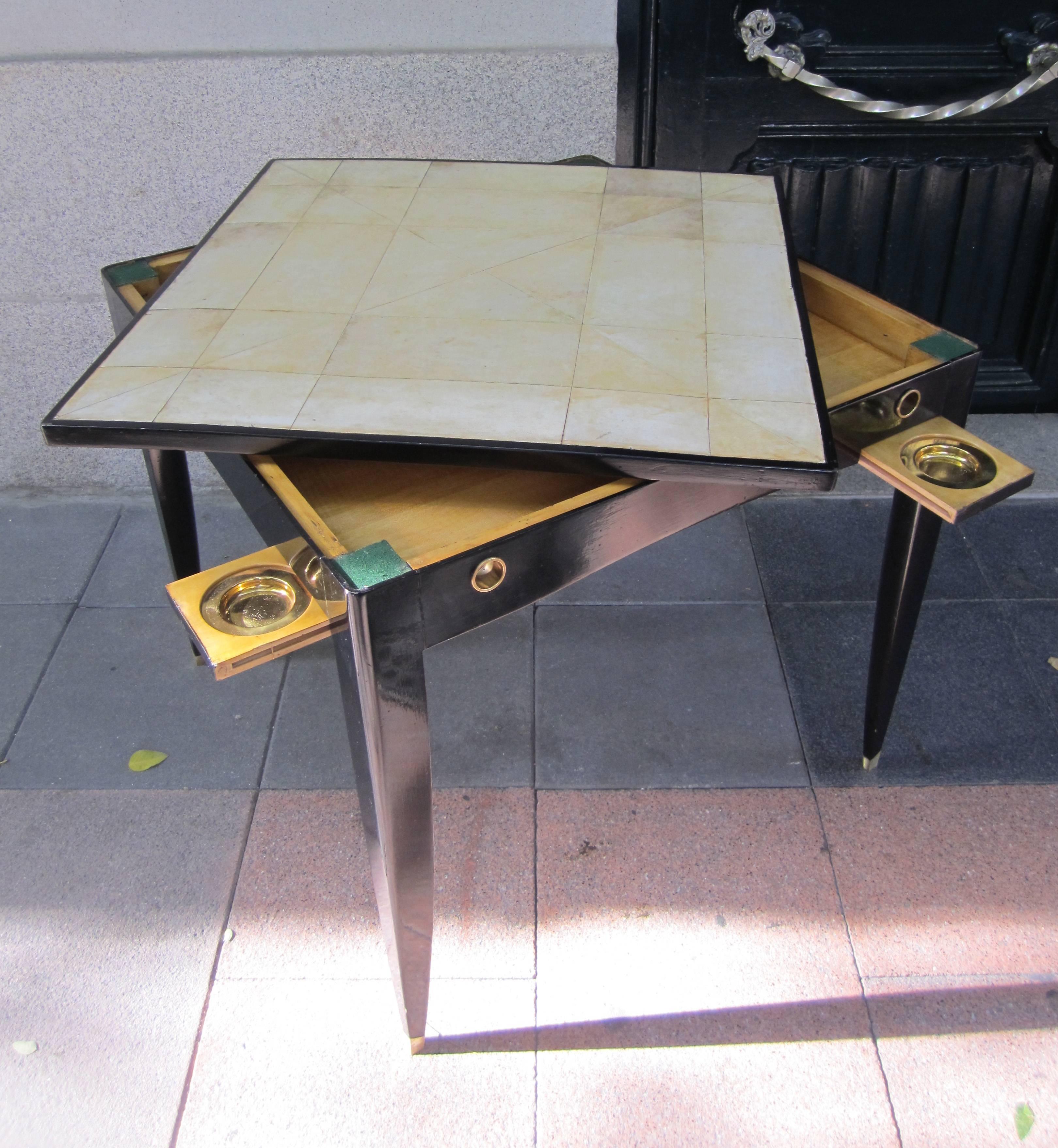 A parchment and suede top, lacquered wood and four asthrays card table, Italy, 1950.