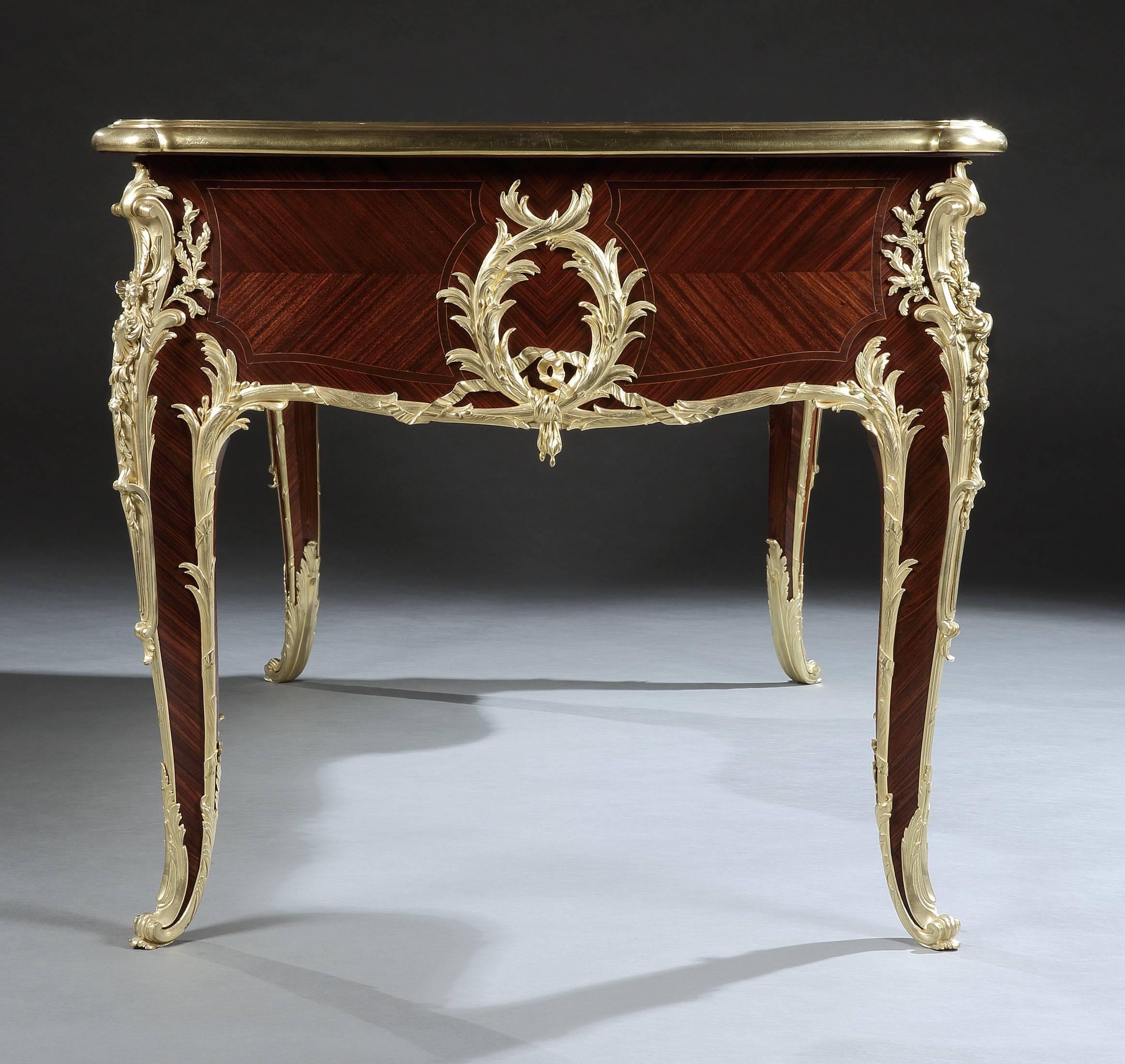 A bureau plat in the Louis XV Style by Françoise Linke.

Of serpentine, kneehole form; constructed in kingwood, and dressed with very fine gilt bronze mounts; rising from cabriole legs dressed with bronze sabots, issuing foliate form mounts