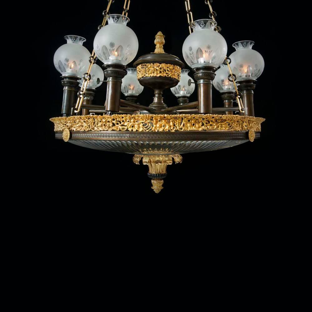 An important ormolu and bronzed dish light the main ring supporting a flute cut-glass dish terminating with an ormolu leaf decorated corona and flower head finial. The main scrolled decorated knurled ring surmounted with flower rosettes and a leaf