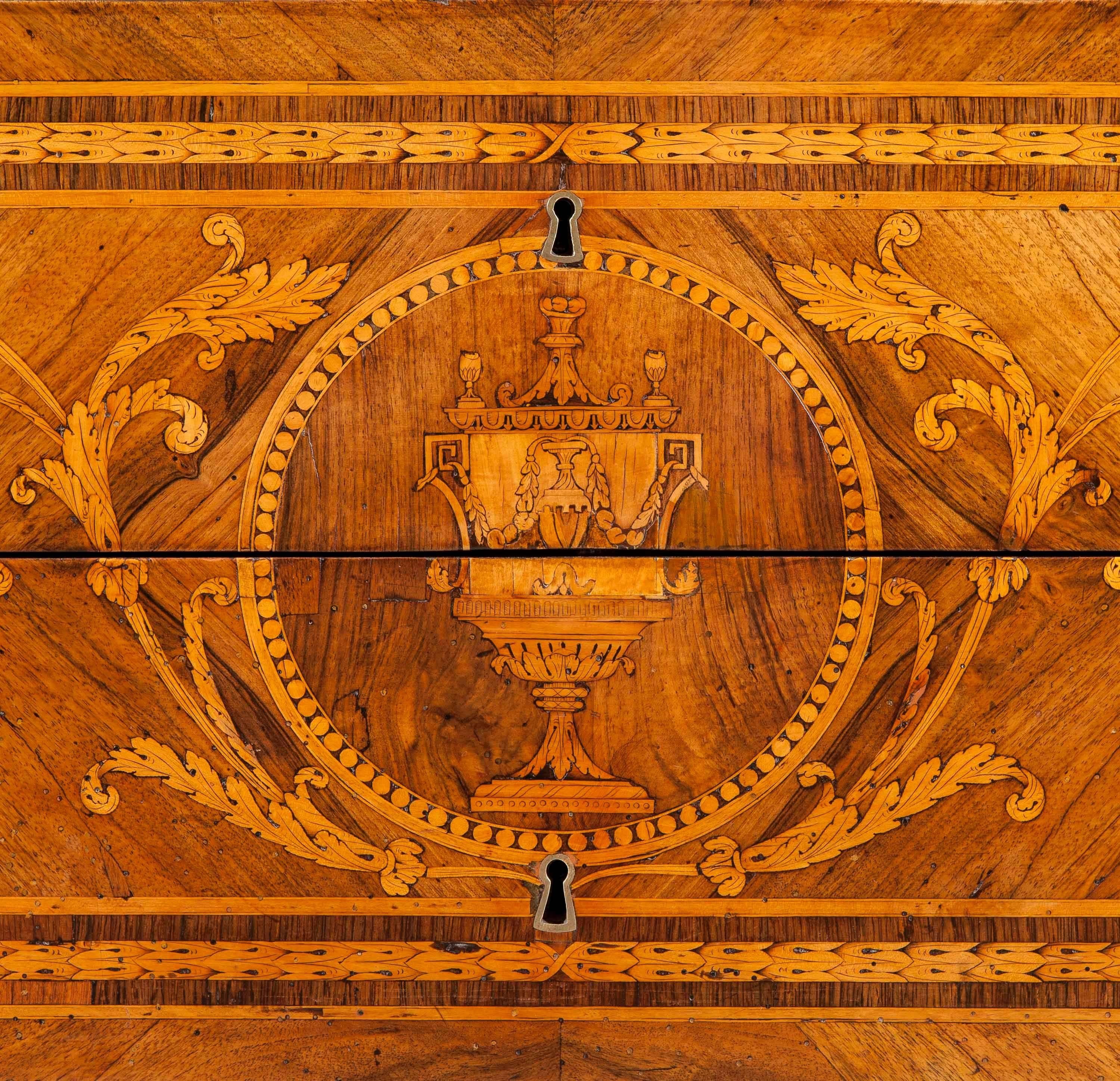 A North Italian commode in the Manner of Guiseppe Maggiolini

Of rectangular form, constructed in walnut, with intarsia work in goncalo alves, olivewood and kingwood, having acquired an overall splendid patination.
Rising from square tapering