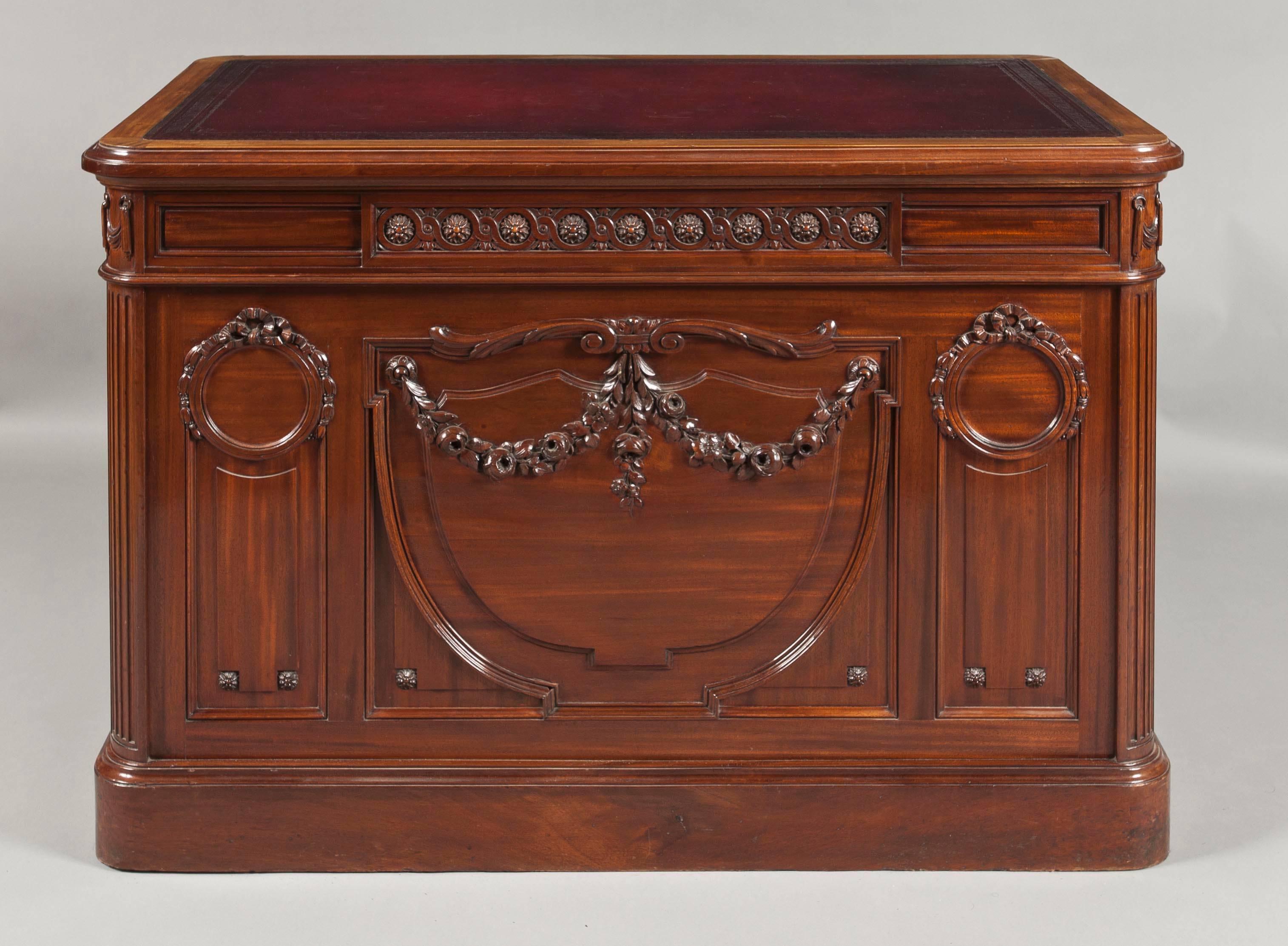 Freestanding, and of elegant and petite design, being constructed in San Domingo mahogany; rising from a plinth base, with pedestals, radiused and reeded at the angles, having fielded panels dressed with paterae, which house fielded panel lockable